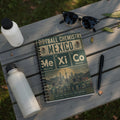 Notebook with "Football Chemistry" and Mexican team graphics, featuring city names.