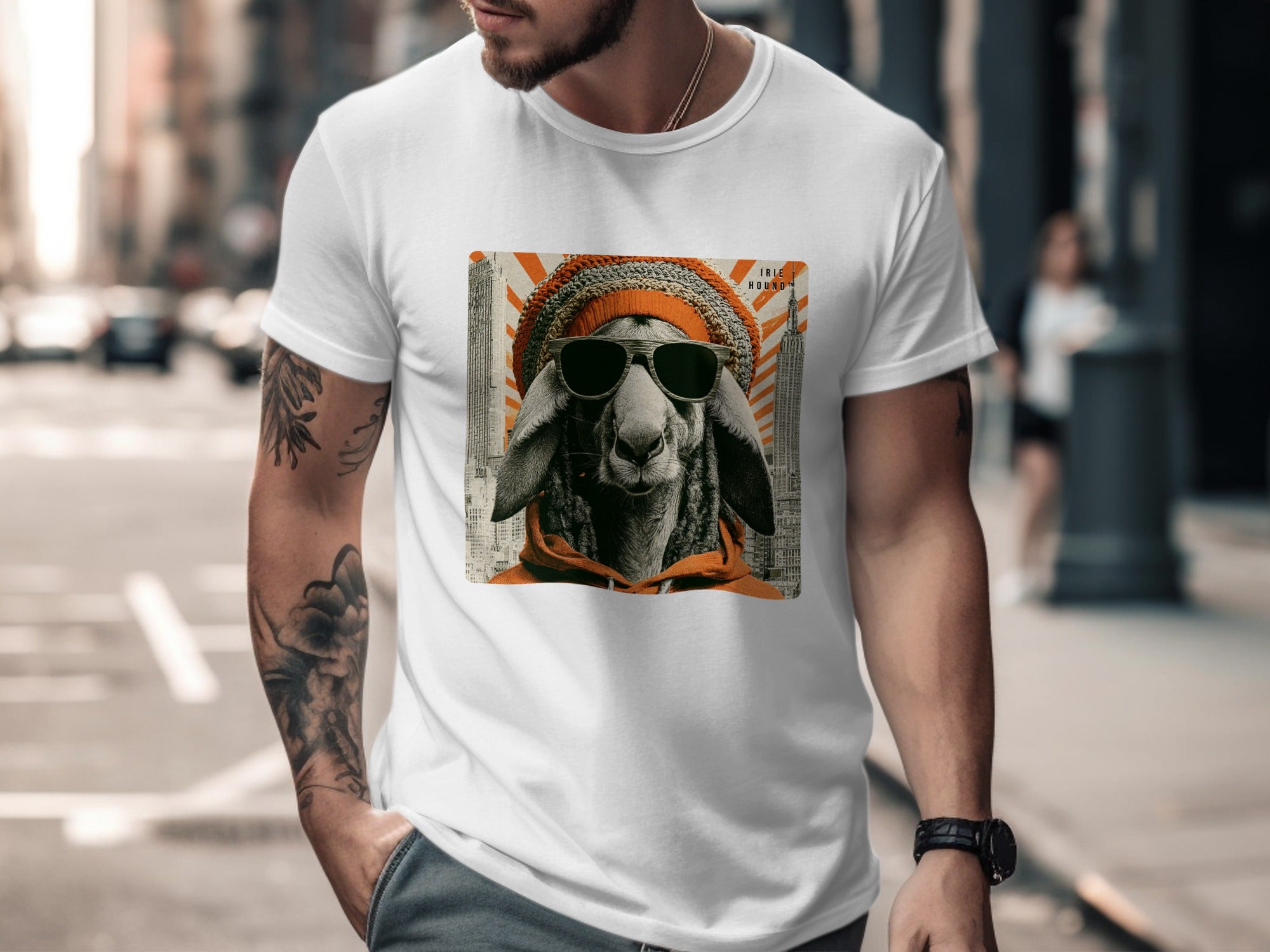 Man wearing white t-shirt with sheep graphic and orange beanie.