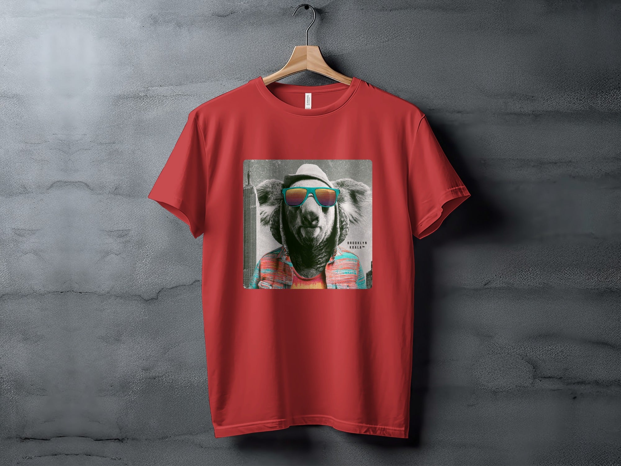 Red t-shirt with a stylized koala wearing sunglasses and a hat.