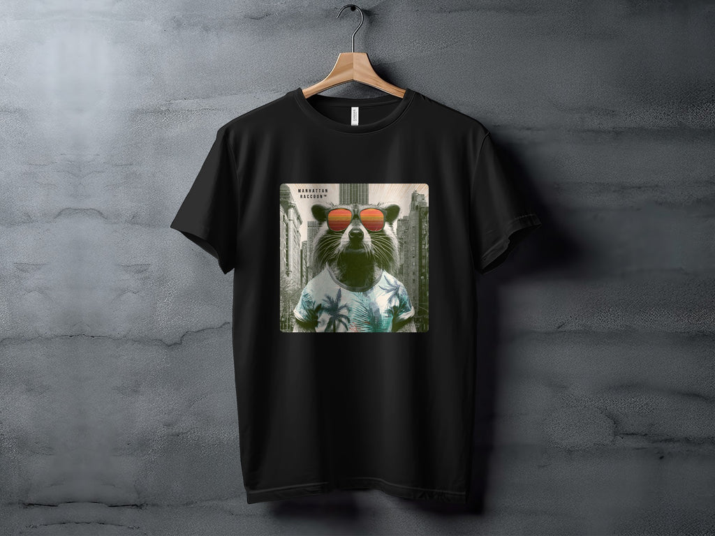 Black t-shirt featuring a raccoon in sunglasses and a tropical shirt, with text "MANHATTAN RACCOON".