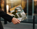 Woman holding a magazine titled "DOWNTOWN KOALA" with a graphic of a koala in sunglasses.