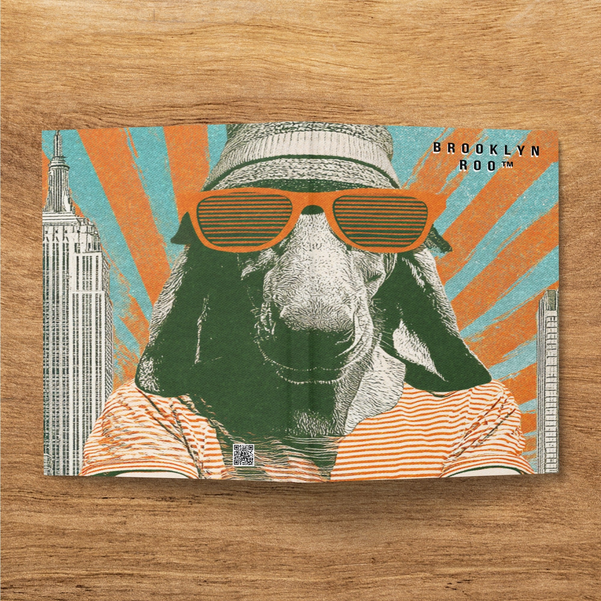 Goat wearing sunglasses and striped shirt with Brooklyn Roo logo.