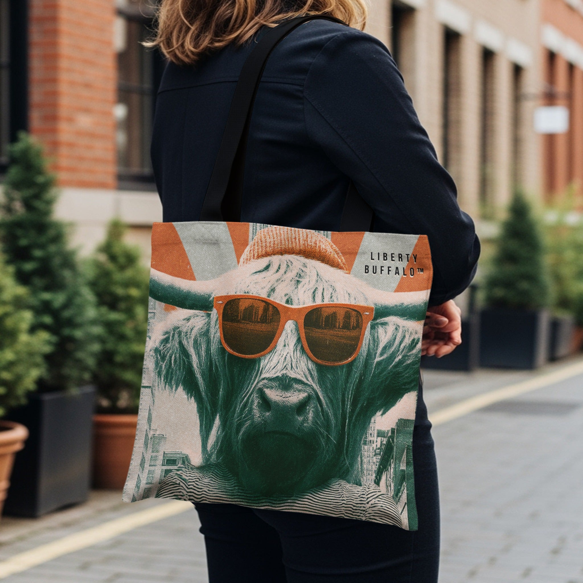 Tote bag featuring a Highland cow wearing sunglasses and a beanie, with "LIBERTY BUFFALO" text.
