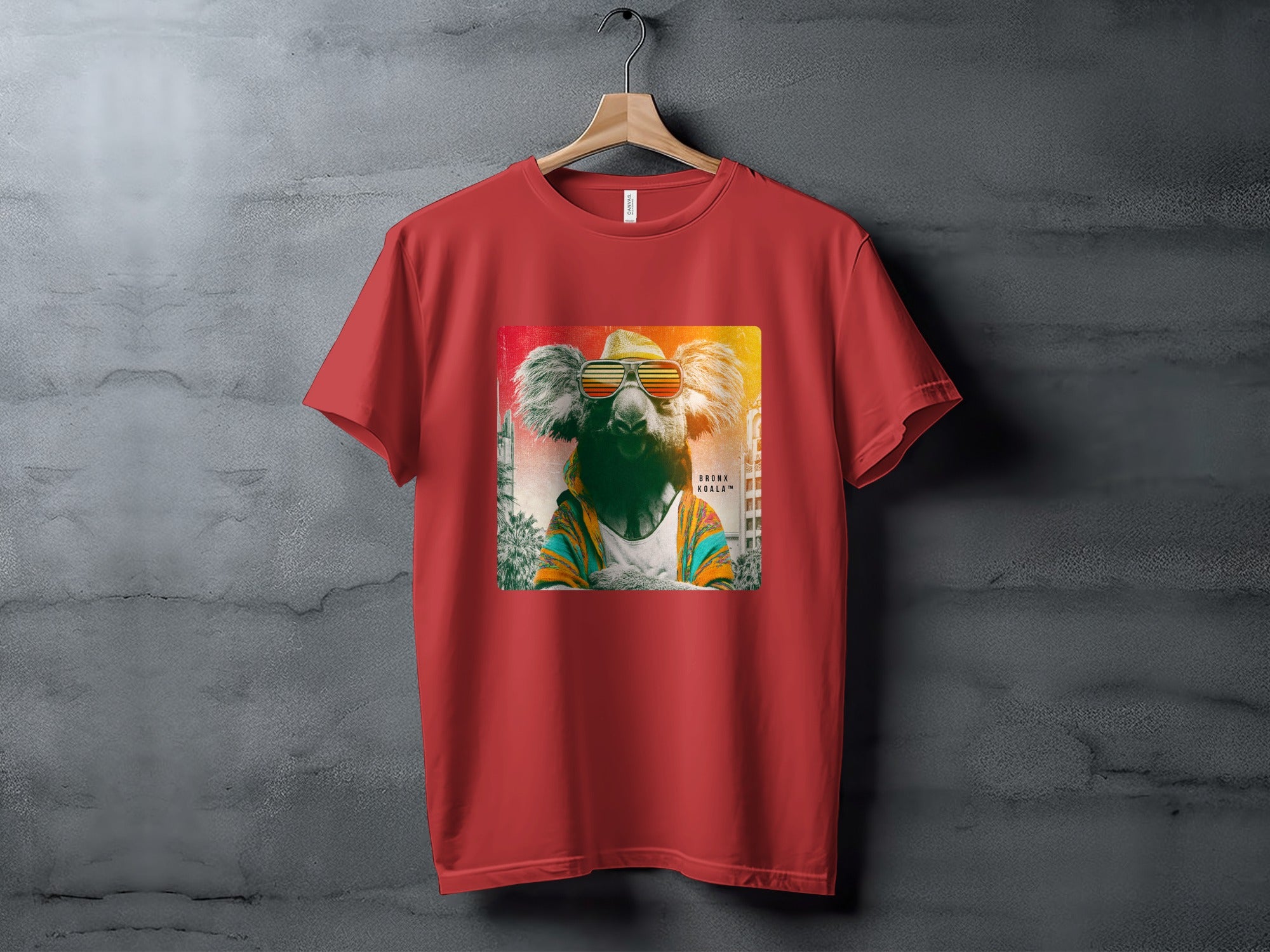 Red t-shirt featuring a stylized koala wearing sunglasses and a colorful jacket.
