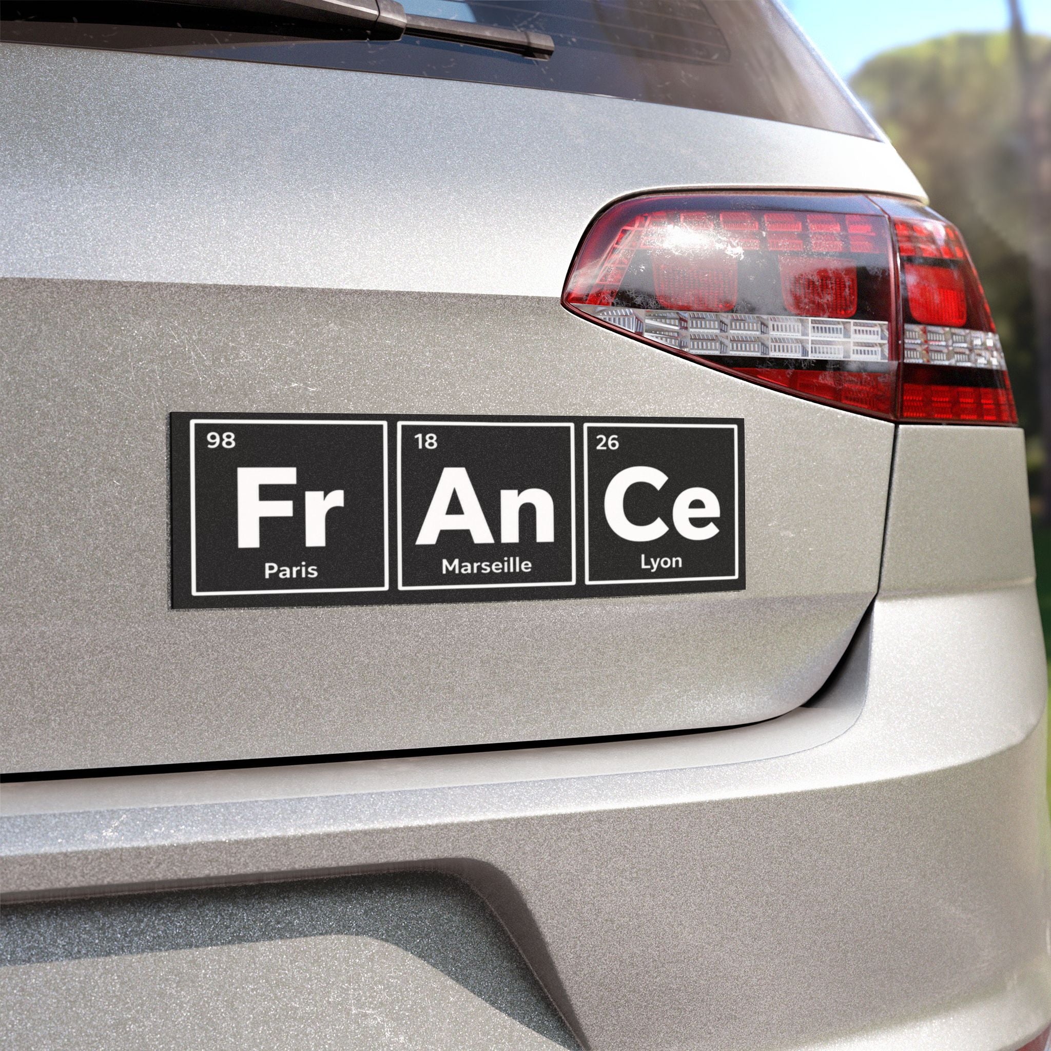 Car decal with "Fr An Ce" in periodic table style, with city names Paris, Marseille, Lyon.