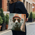 Tote bag with graphic of a koala wearing sunglasses and hat, Eiffel Tower in background.