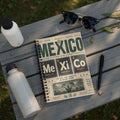 Notebook with "El Fútbol es de la Gente" and Mexican cities, symbolizing football.