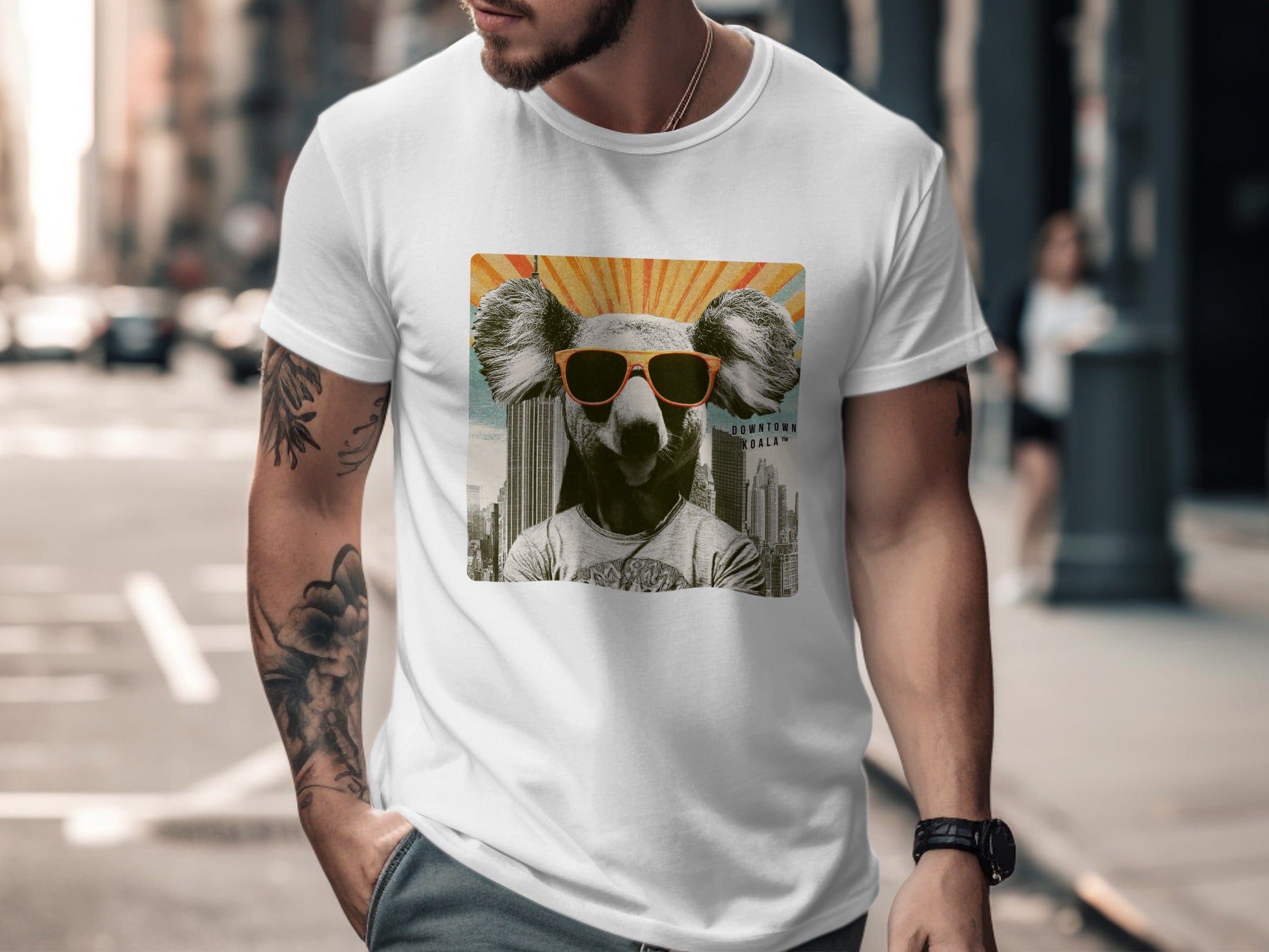 Man wearing white t-shirt with graphic of koala wearing sunglasses and sunburst.