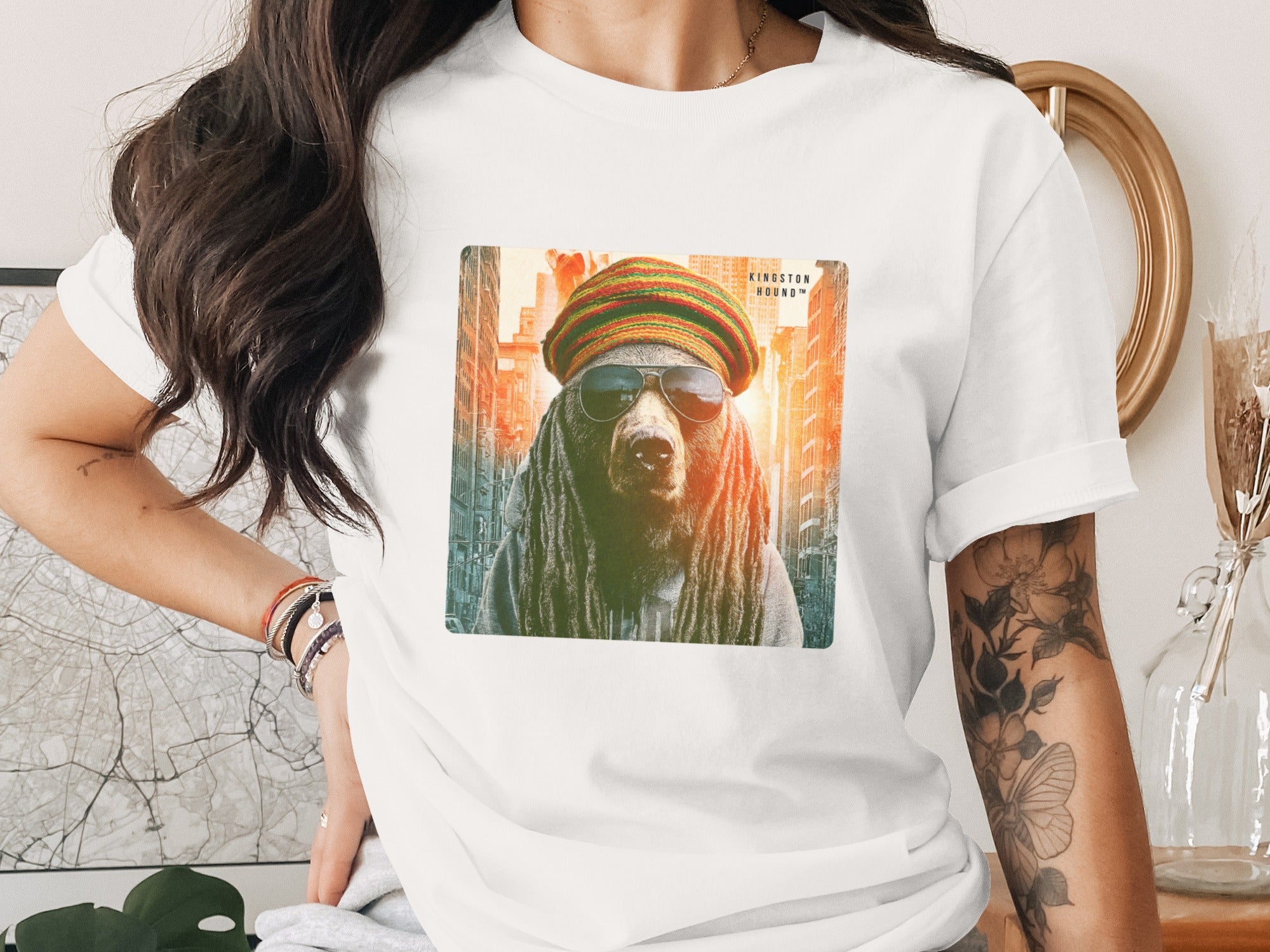 Bear wearing sunglasses and a beanie, with a city skyline behind it.