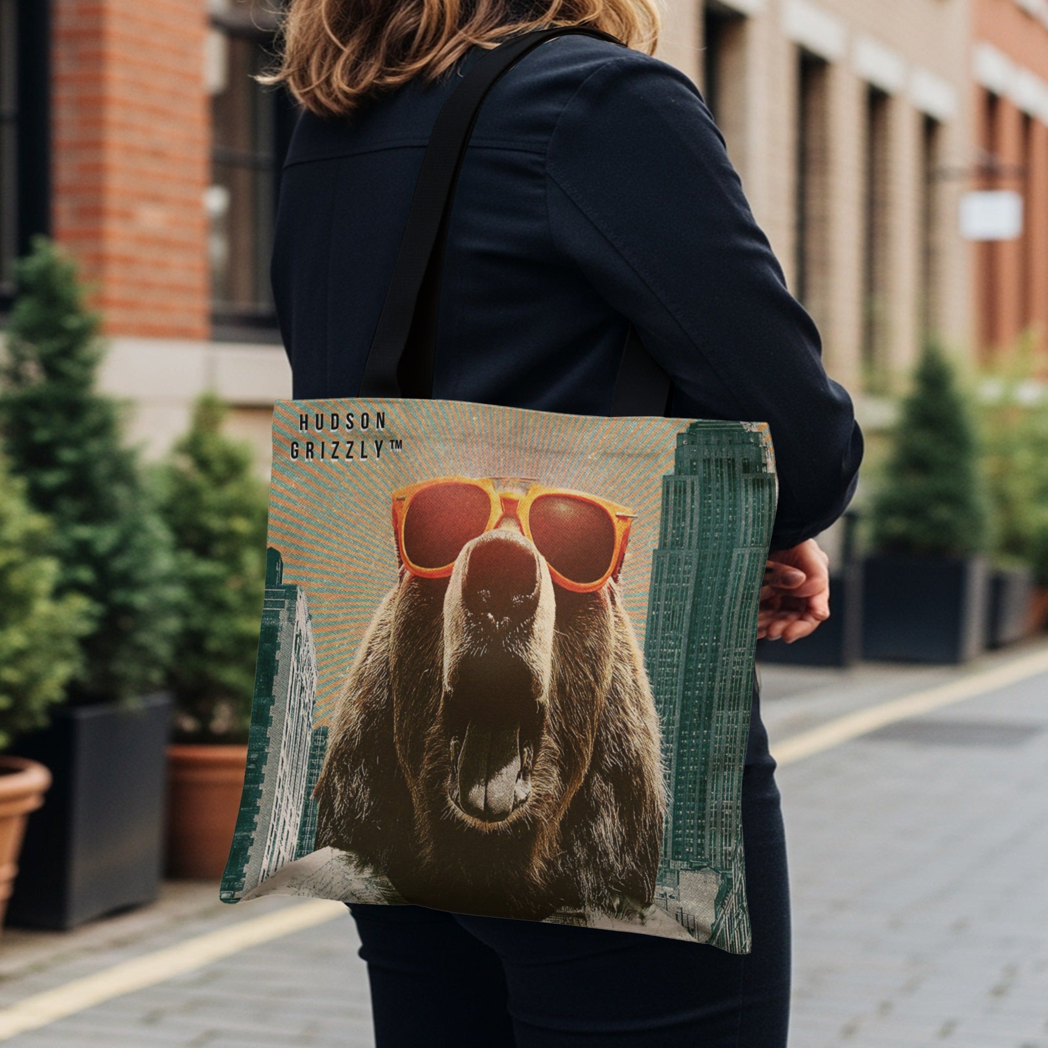 Tote bag with a roaring grizzly bear wearing sunglasses and skyscrapers.