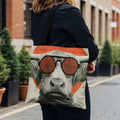 Tote bag with a close-up of a bull wearing large orange-rimmed sunglasses.