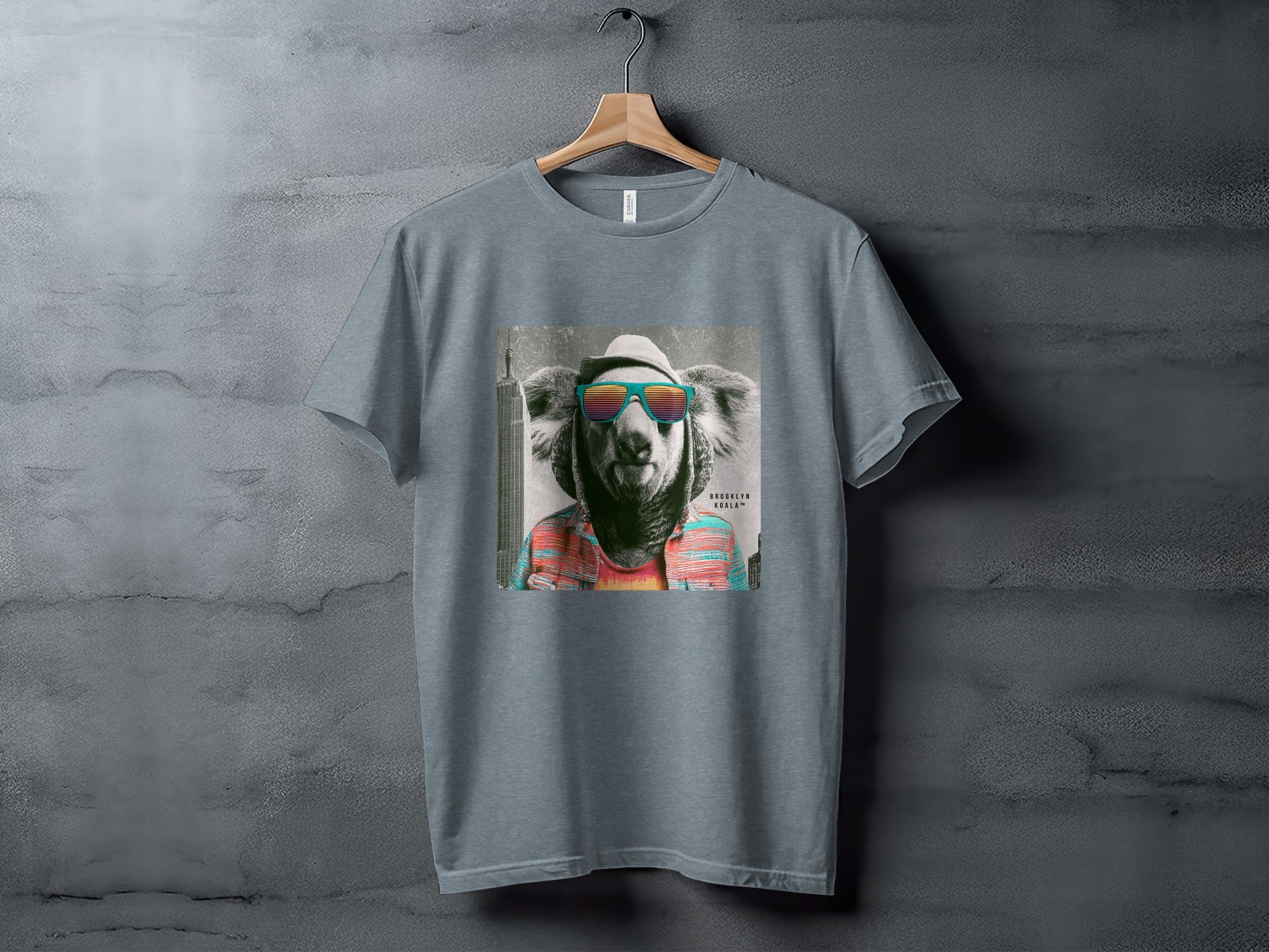 Grey t-shirt with a graphic of a koala wearing sunglasses and a hat.