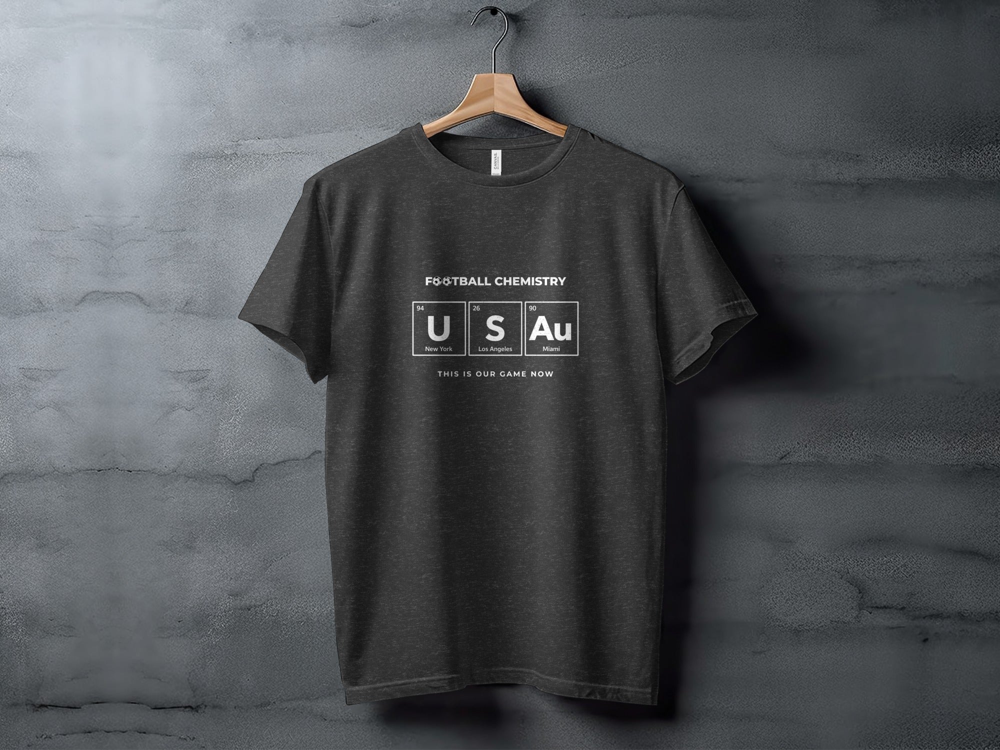 Dark grey t-shirt with "FOOTBALL CHEMISTRY" and US Au periodic table elements.