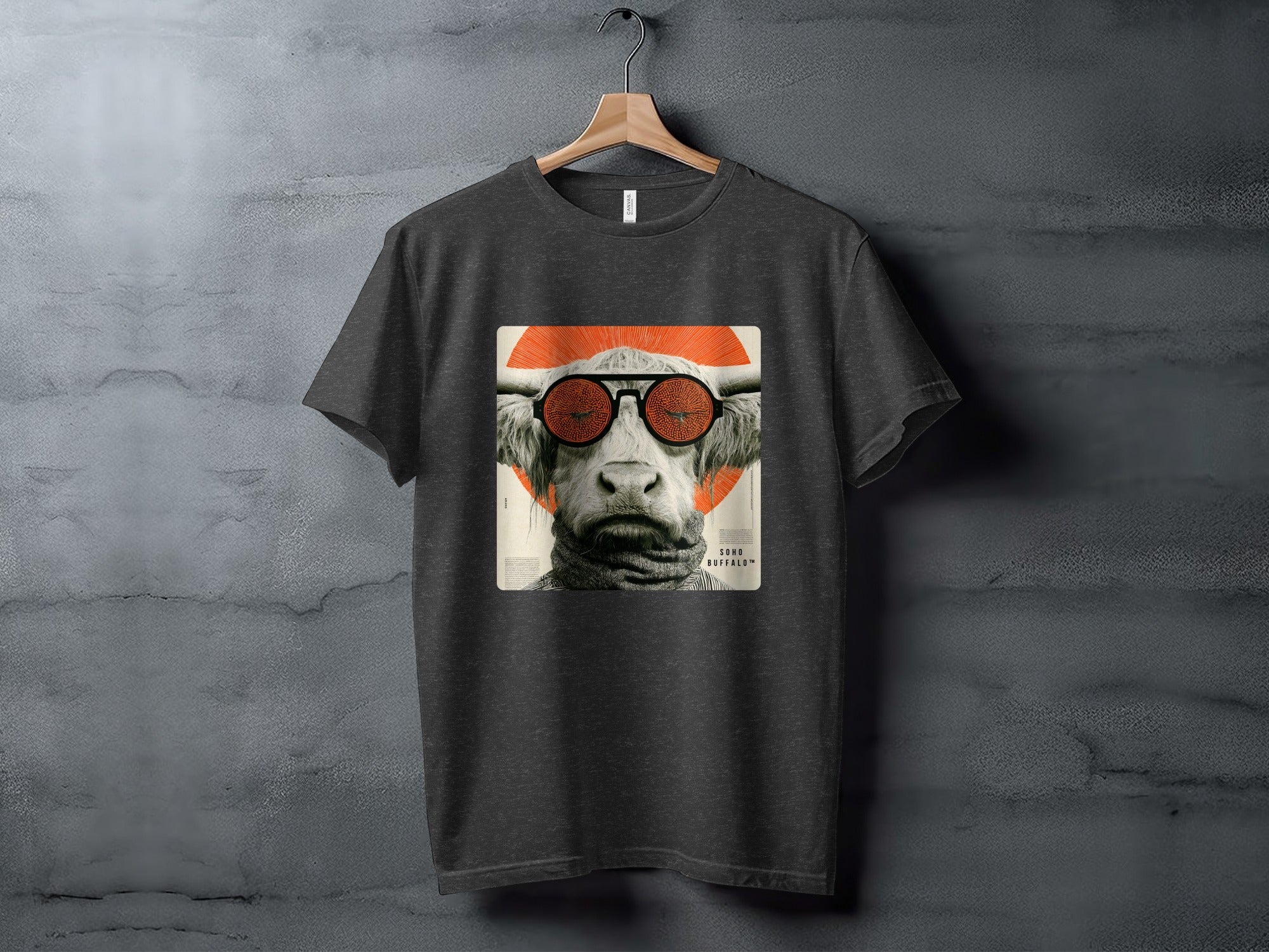 T-shirt with graphic of a cow wearing sunglasses and a patterned scarf.