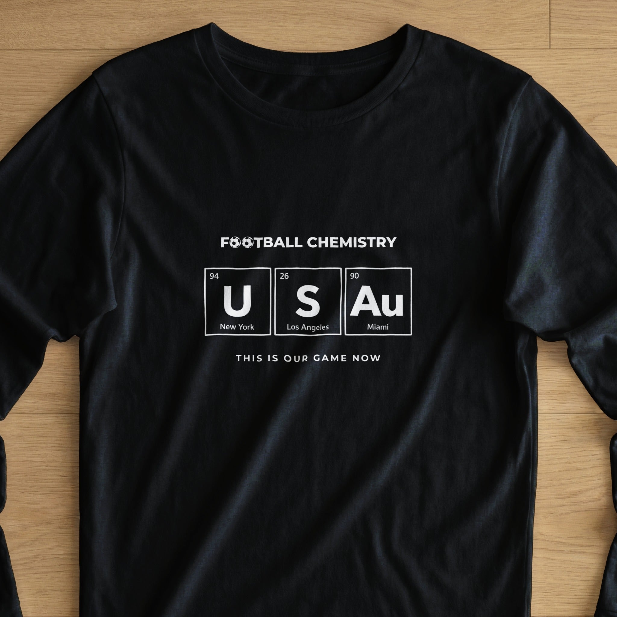 Black t-shirt with "FOOTBALL CHEMISTRY" and "USA" in periodic table elements.