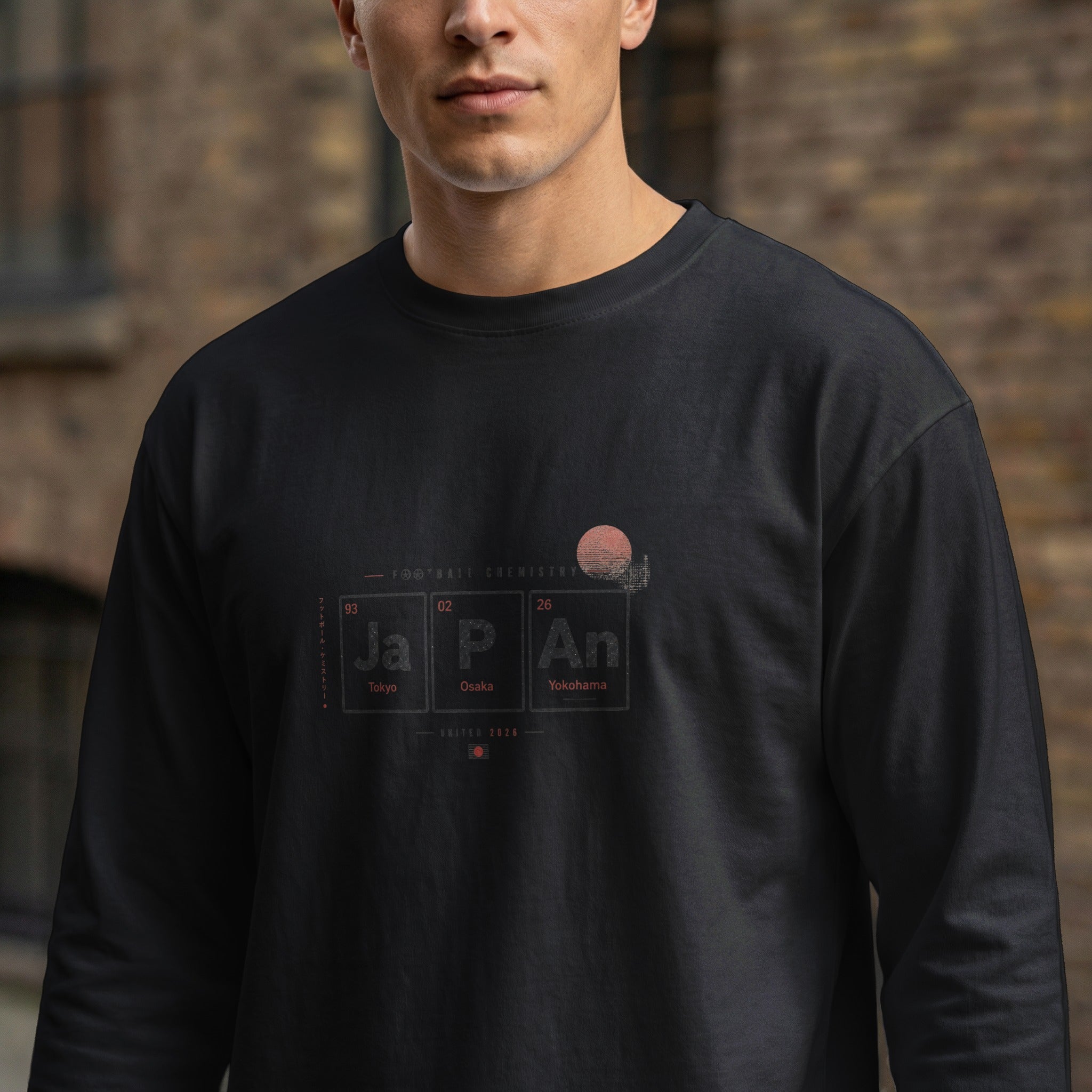 Long-sleeve shirt with "JAPAN" in periodic table style, cities, and "UNITED 2026".