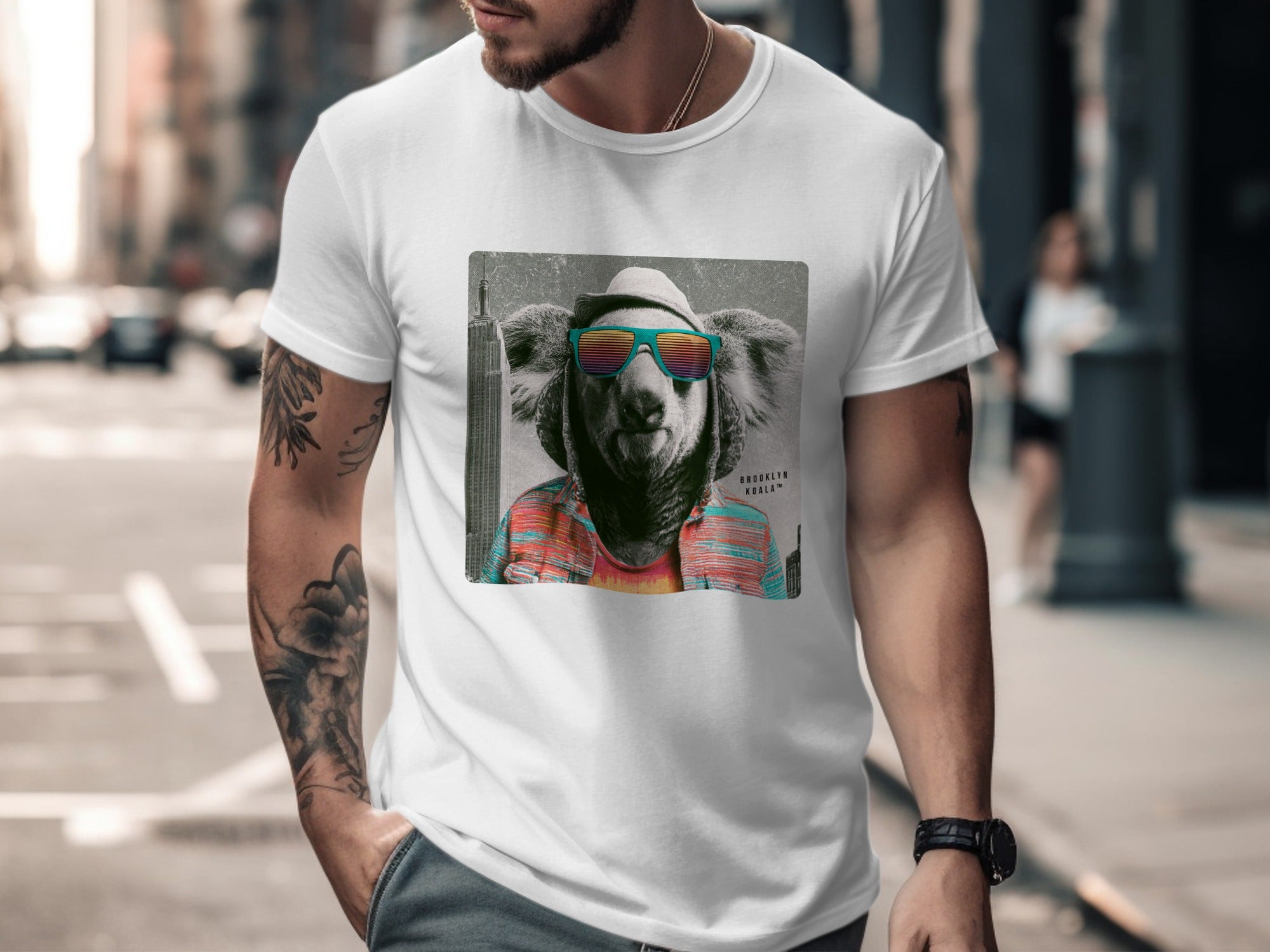 Man wearing a white t-shirt with a Brooklyn Koala graphic.