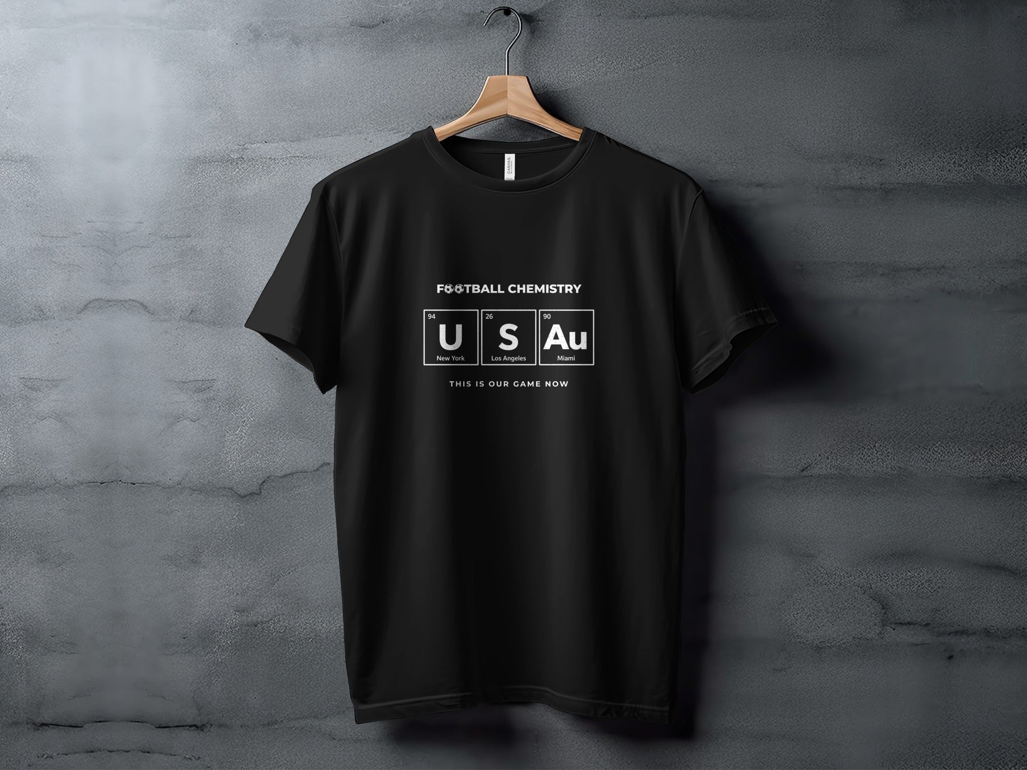 Black t-shirt with "FOOTBALL CHEMISTRY" and periodic table elements U, S, Au.