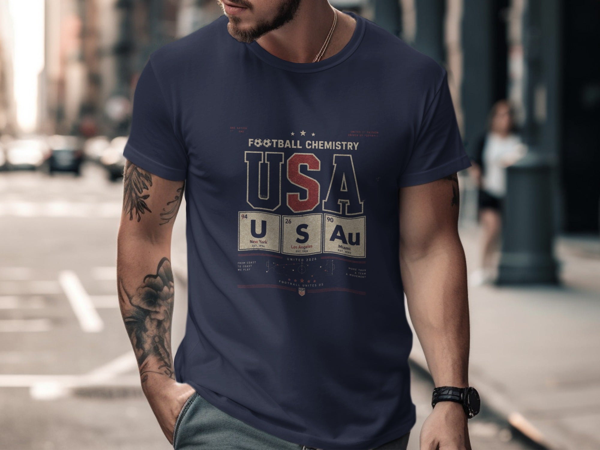 Navy t-shirt with USA Football Chemistry design and city names.