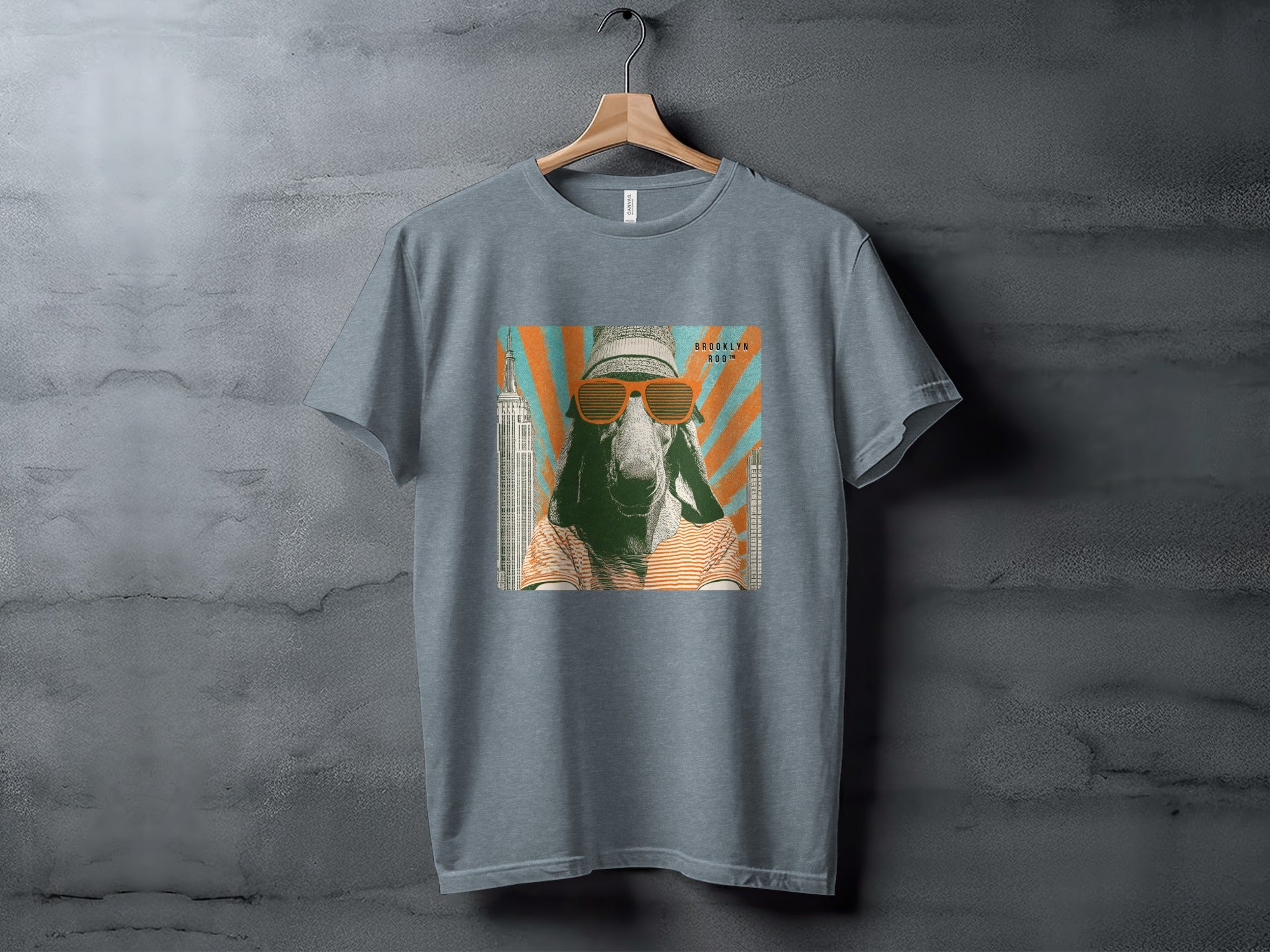 T-shirt with graphic of a goat wearing sunglasses and a hat, with city skyline.