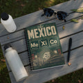 Spiral notebook with "Mexico Football Chemistry" design and city names.