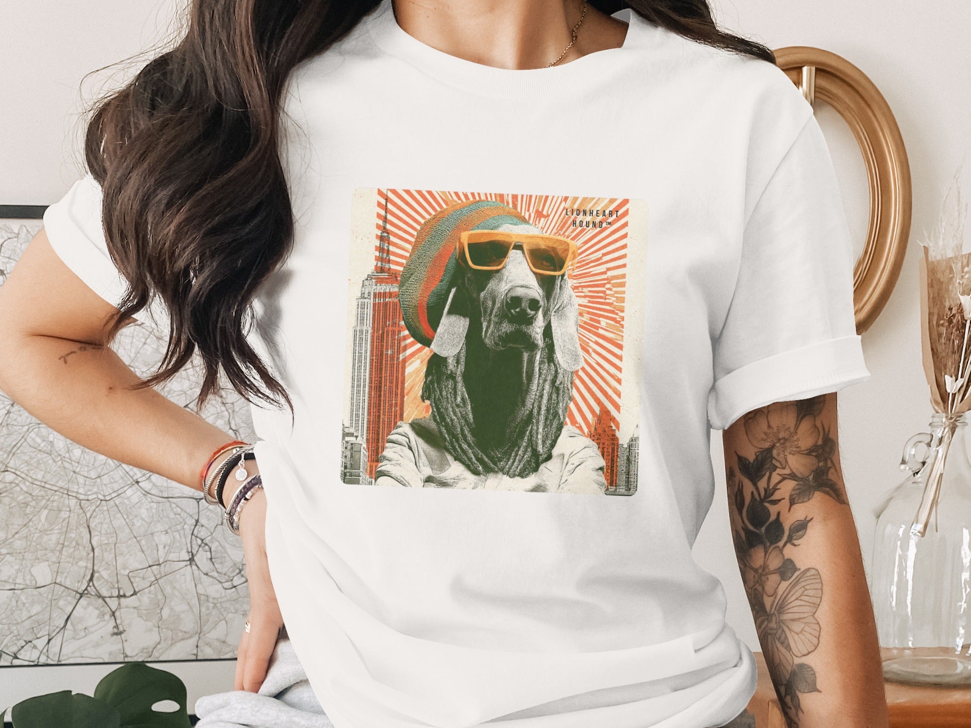 Dog in sunglasses and beret, New York City skyline graphic on white t-shirt.
