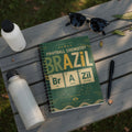 Notebook with "Brazil Football Chemistry" cover featuring periodic table elements and city names.