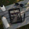 Spiral-bound notebook with "Football Chemistry" cover design and soccer stadium graphic.