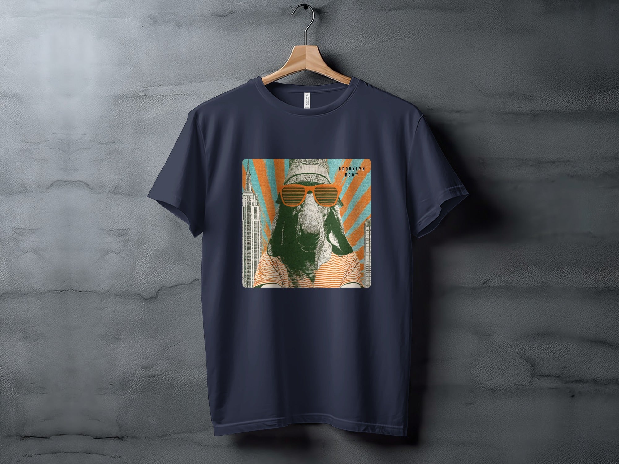 Dark blue t-shirt with a graphic of a goat wearing sunglasses and a striped shirt.