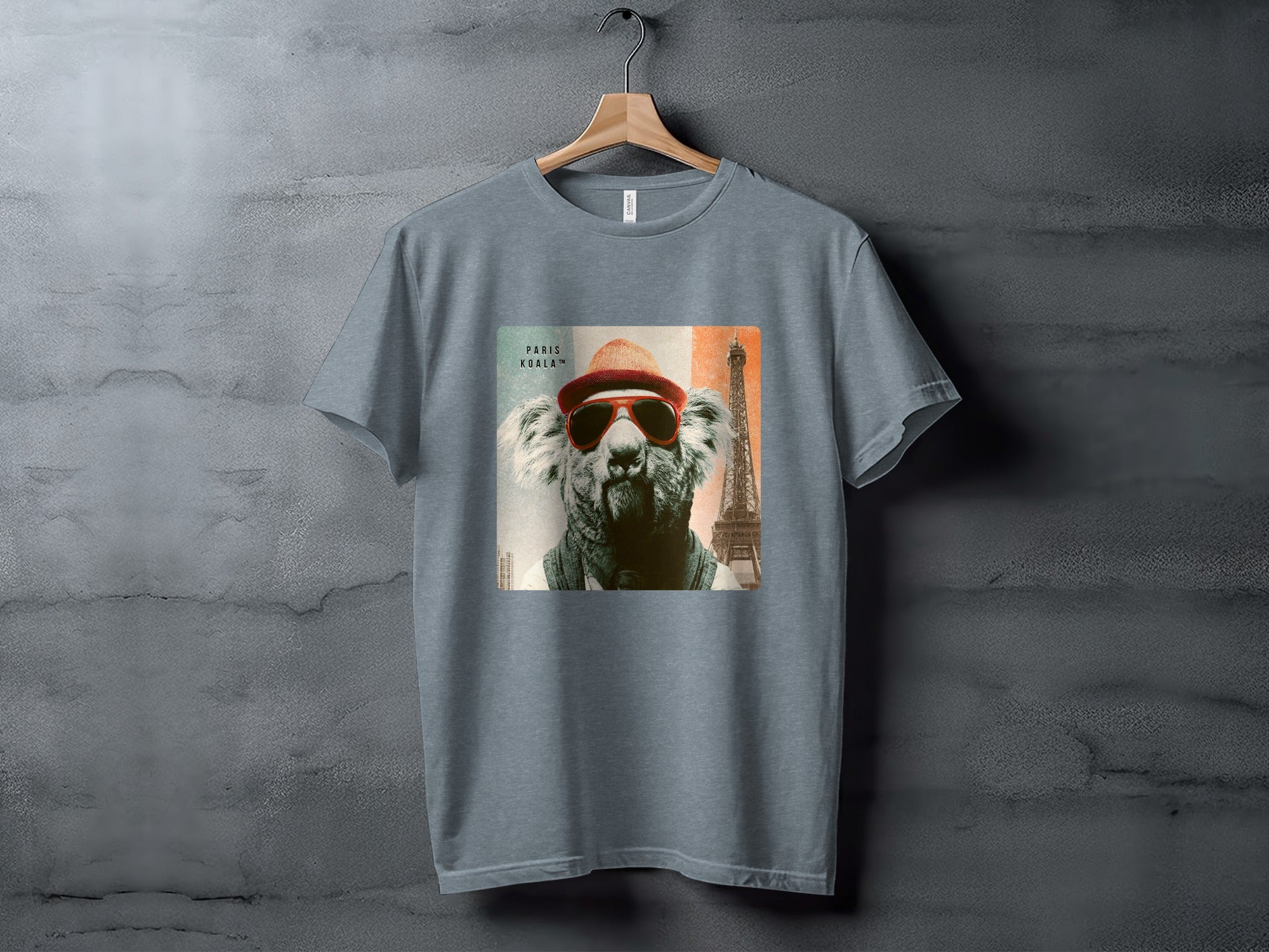 Koala wearing sunglasses and hat with Eiffel Tower in background.