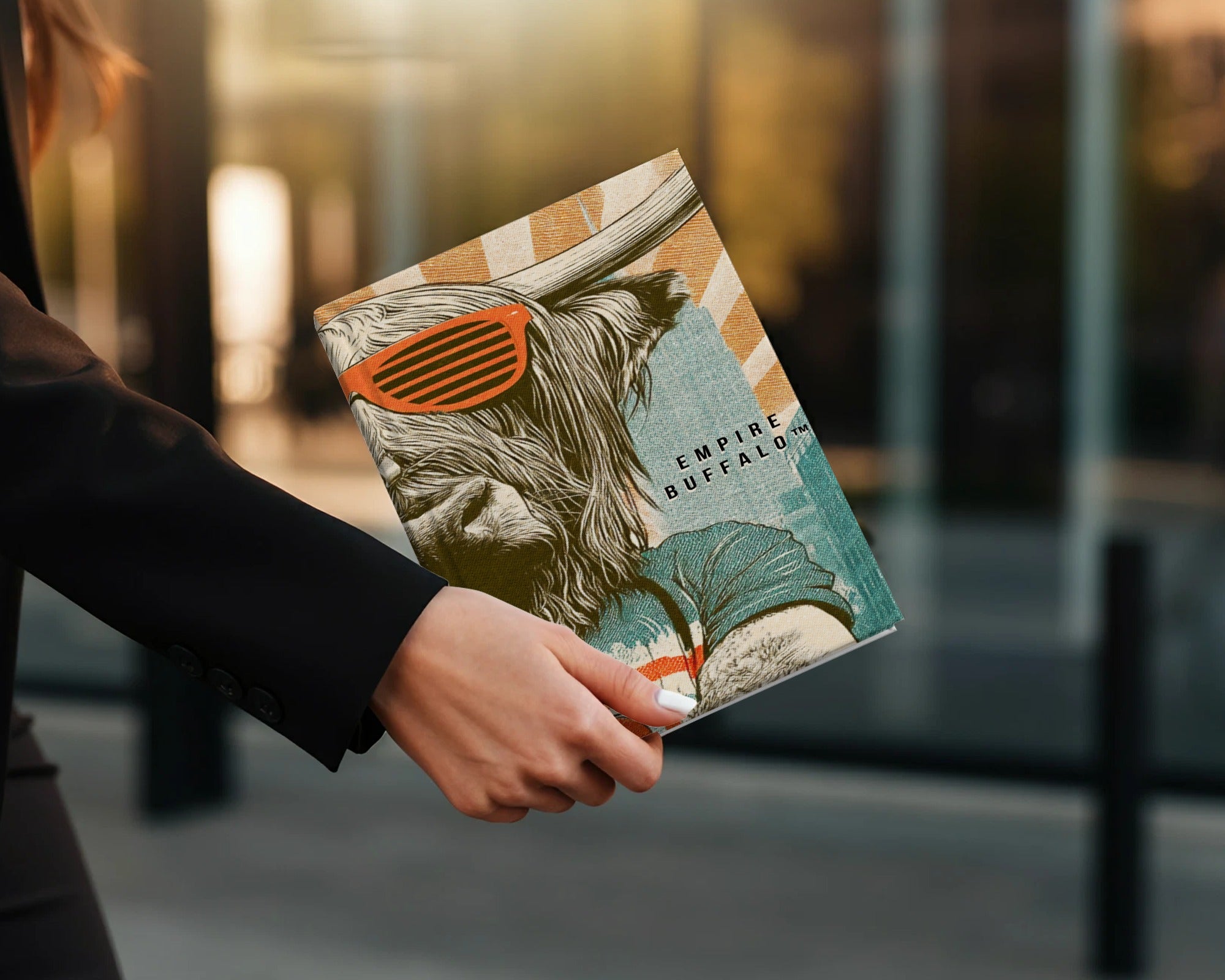 Book cover with a buffalo wearing sunglasses, titled "Empire Buffalo."