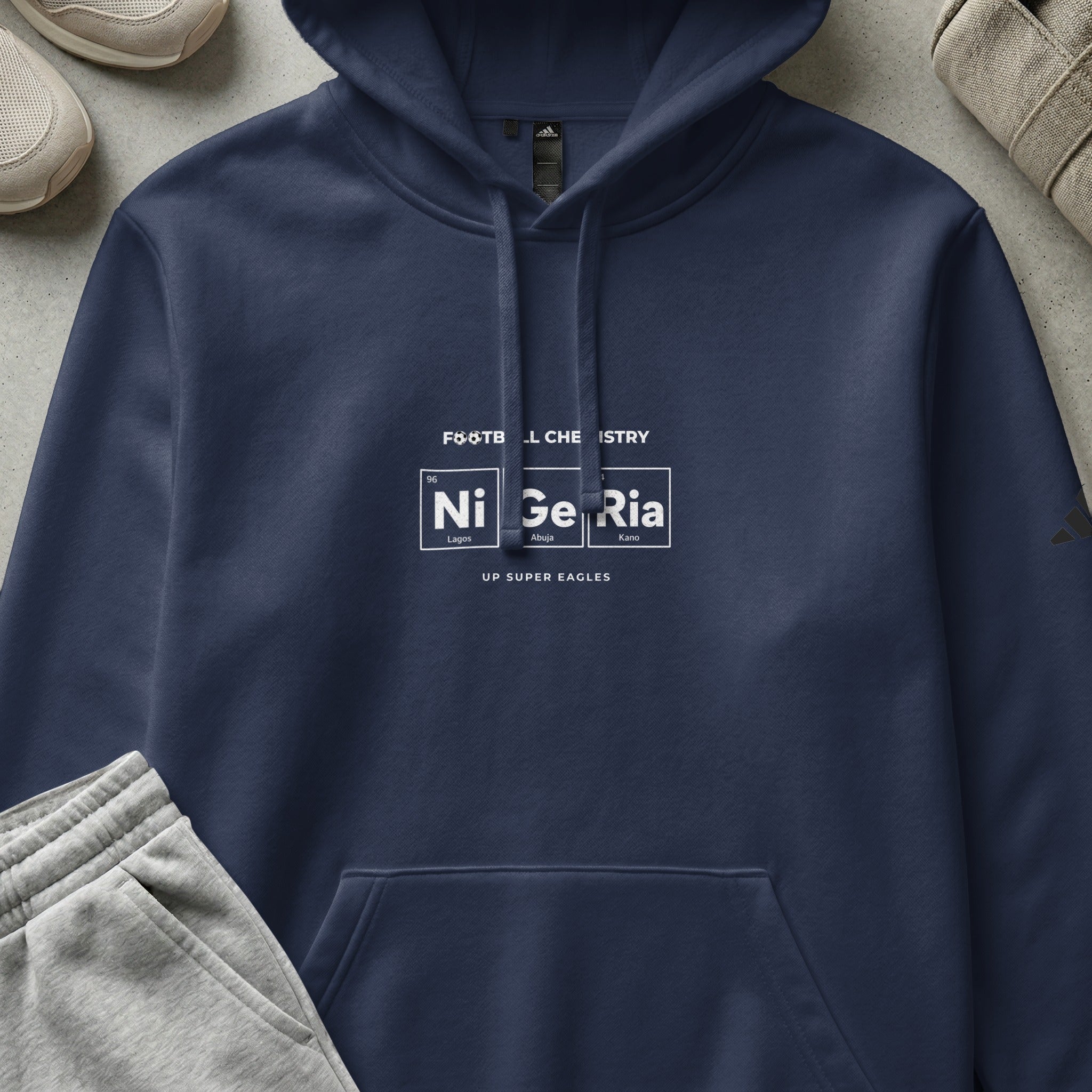 Dark navy hoodie with "Football Chemistry" and "Nigeria" in element style.