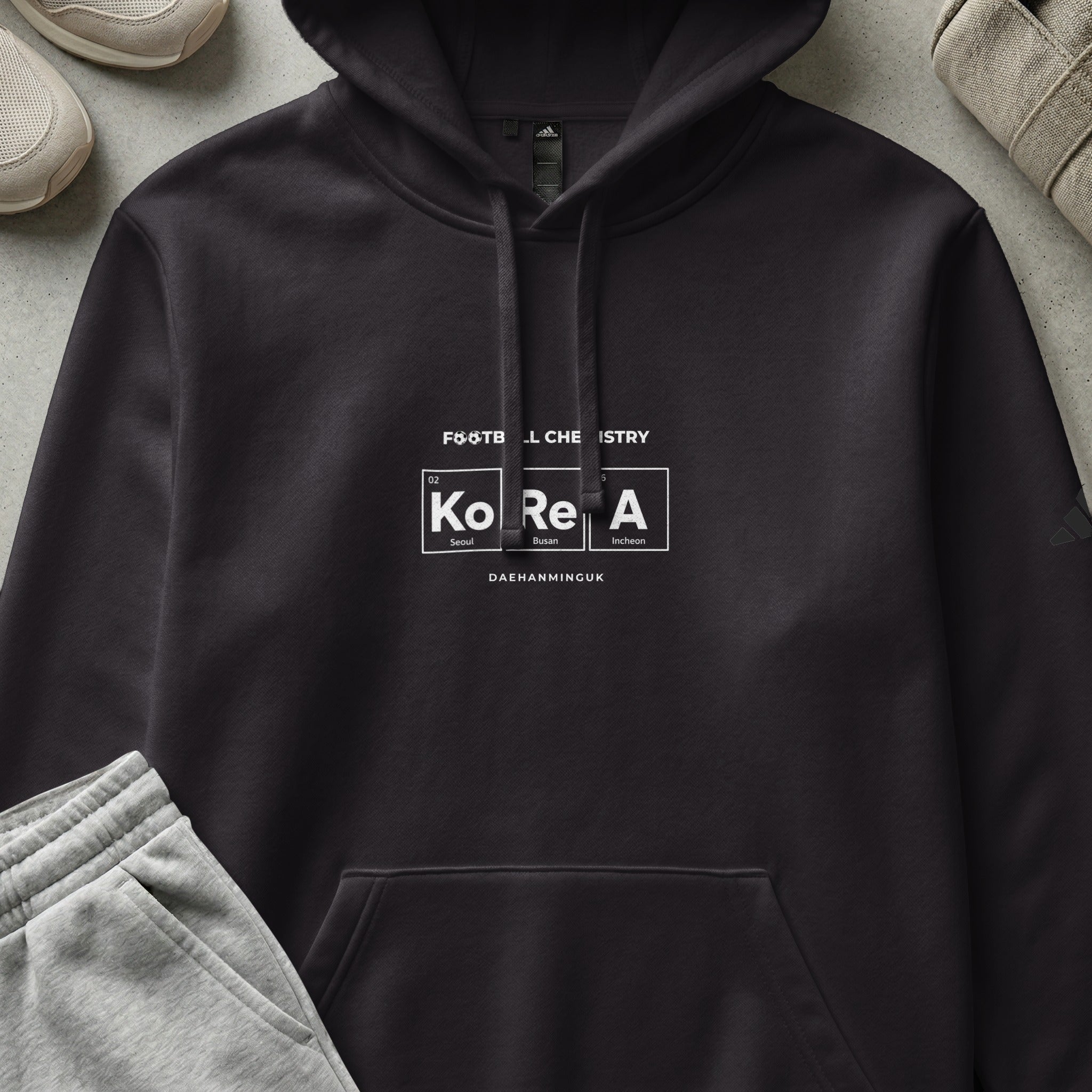 Dark grey hoodie with "Football Chemistry" and "Korea" text in periodic table style.