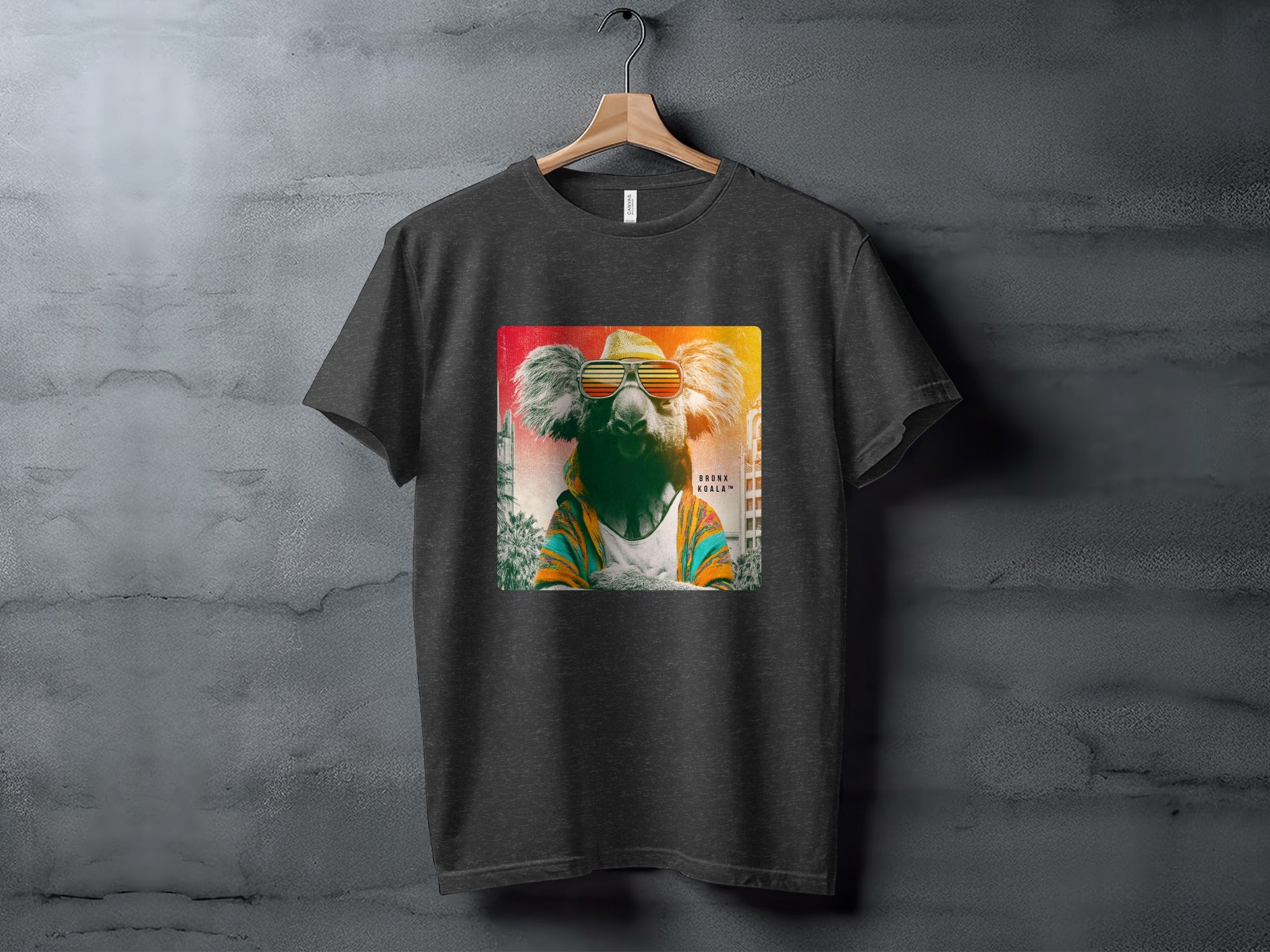 T-shirt with a graphic of a koala wearing sunglasses and a colorful jacket.