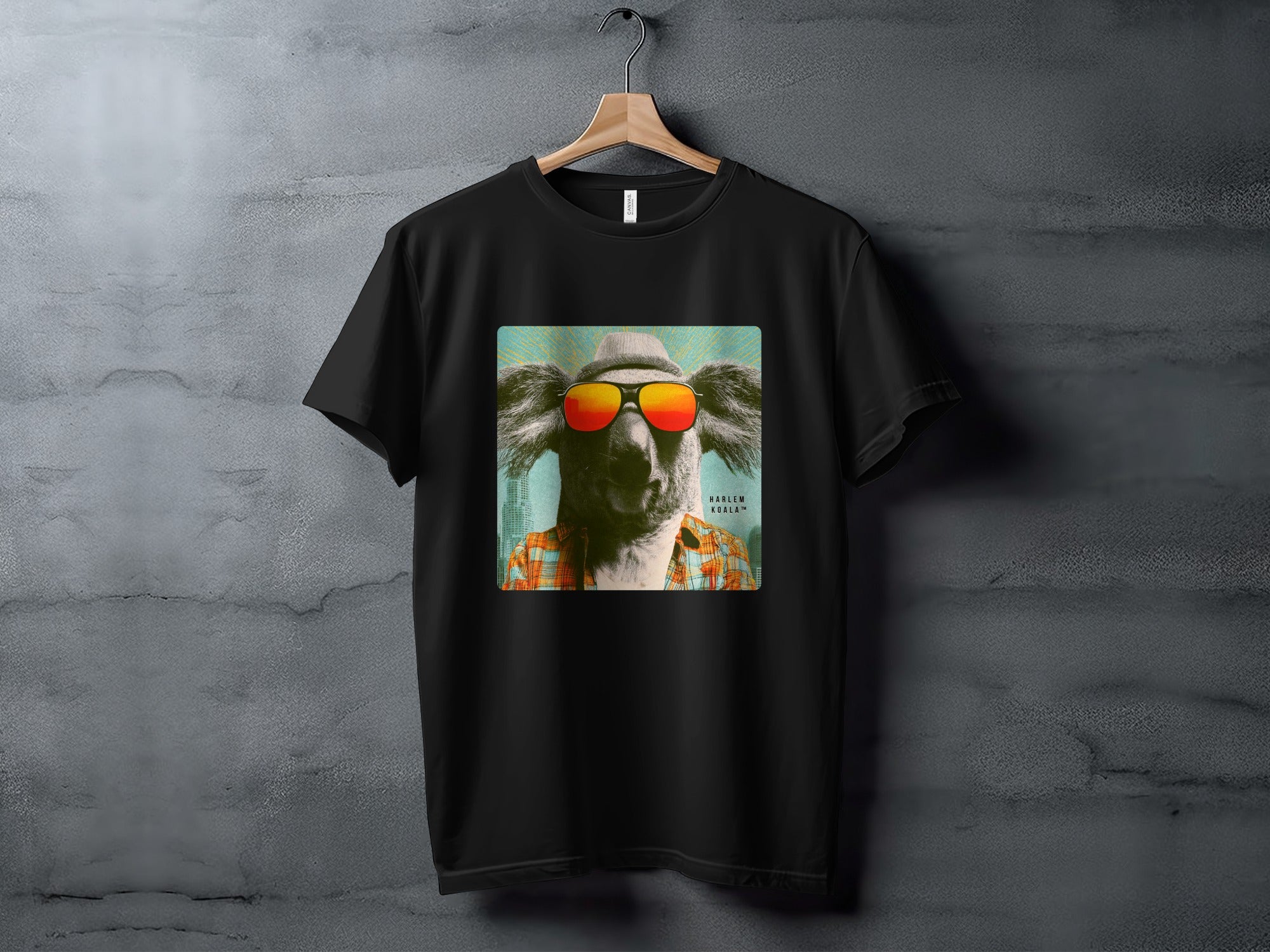 Koala wearing sunglasses and a hat on a black t-shirt.