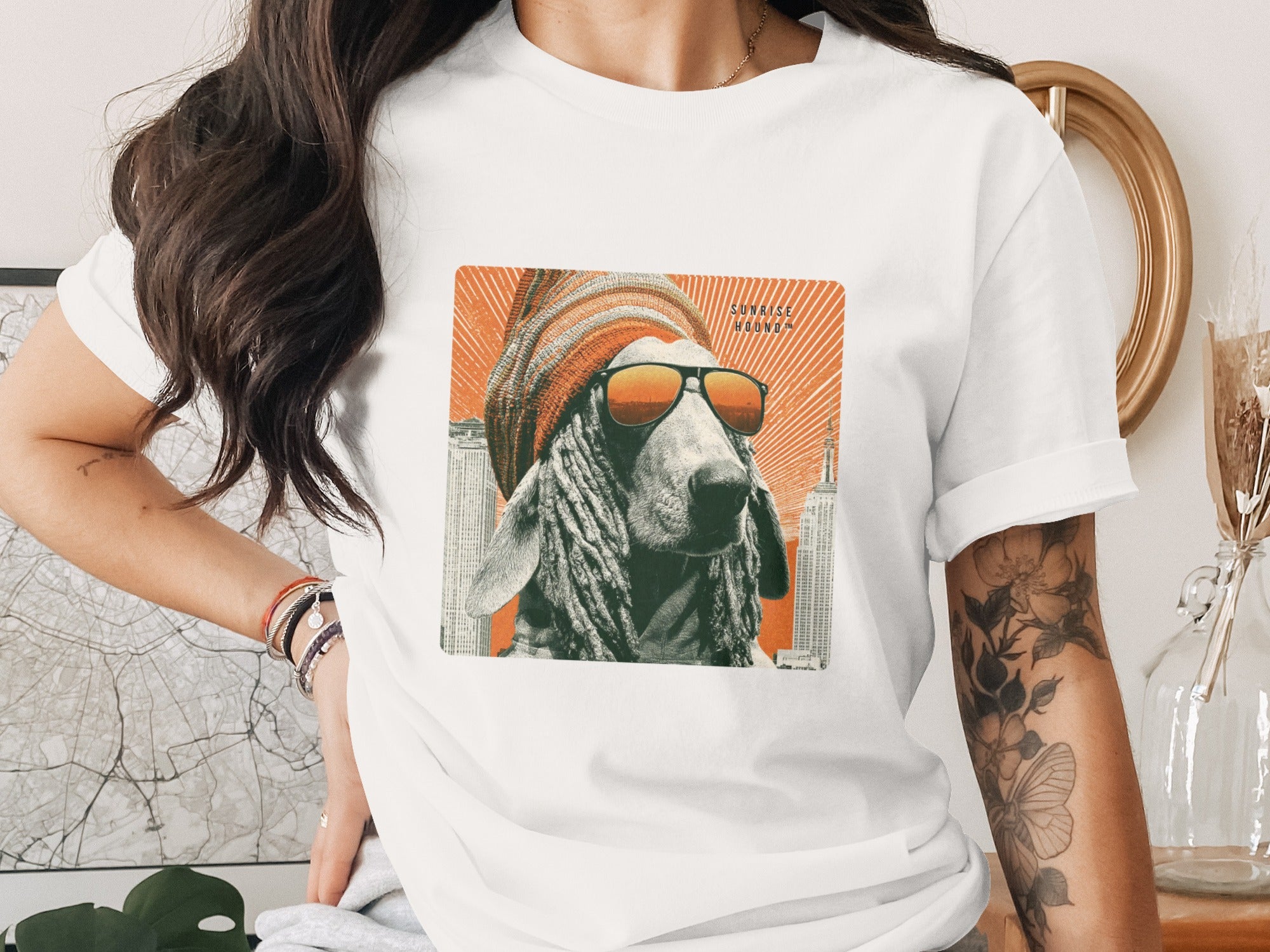 T-shirt with graphic of a dog wearing sunglasses and beanie, city skyline background.