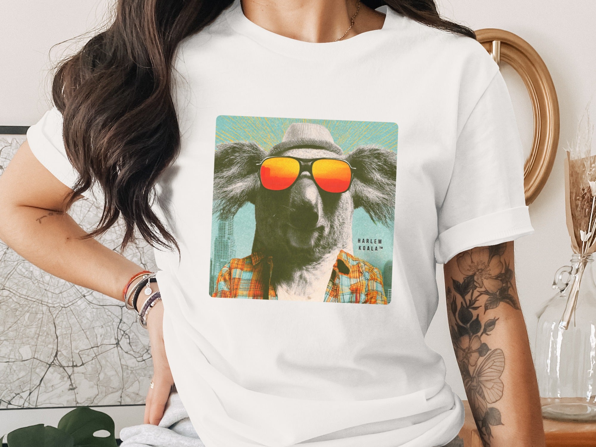 T-shirt with a graphic of a koala wearing sunglasses and a hat.