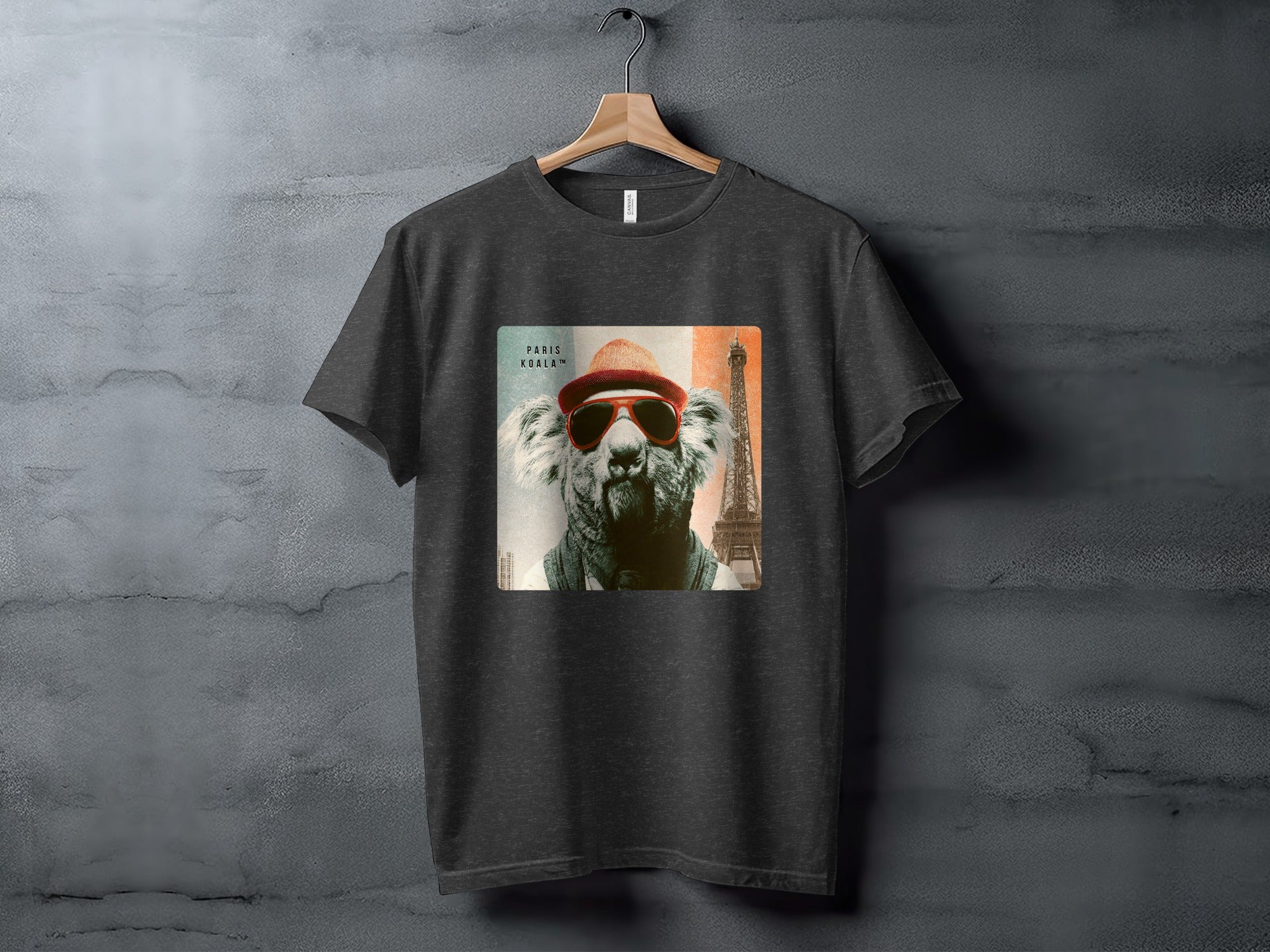 T-shirt graphic of a koala wearing sunglasses and hat with Eiffel Tower backdrop.