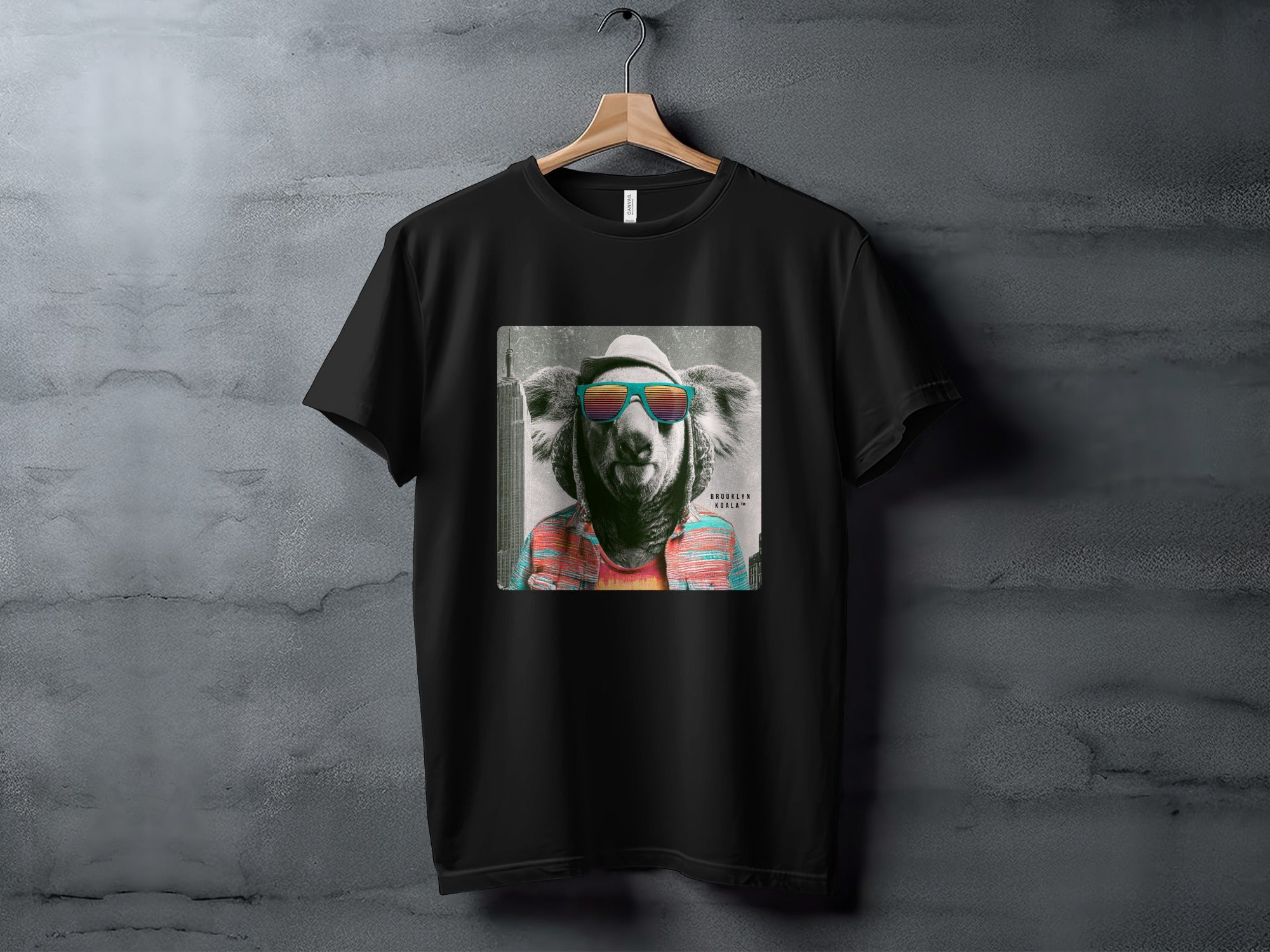 Black t-shirt with a graphic of a koala wearing sunglasses and a hat.