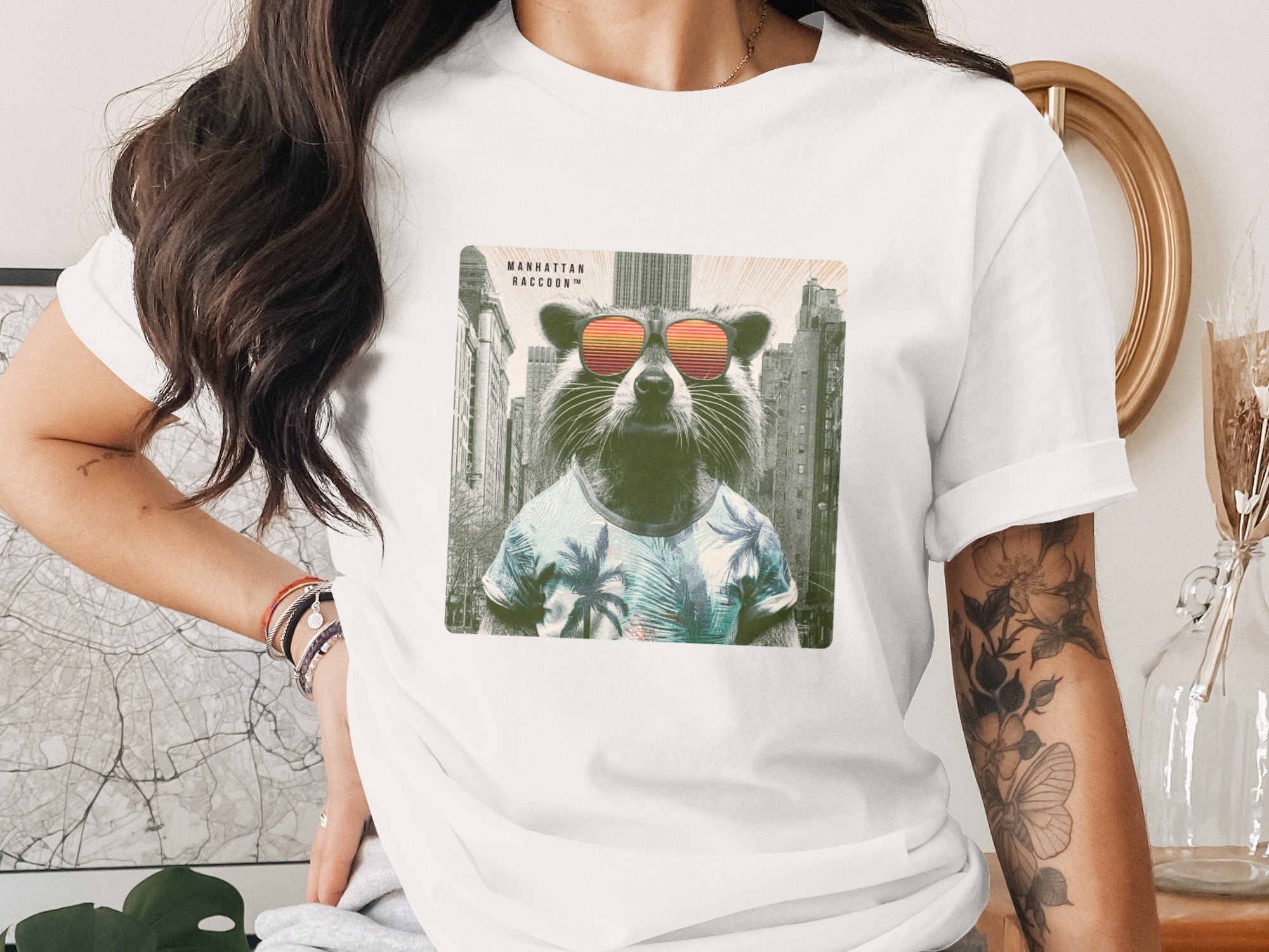 Raccoon wearing sunglasses and a palm tree shirt on a city background.