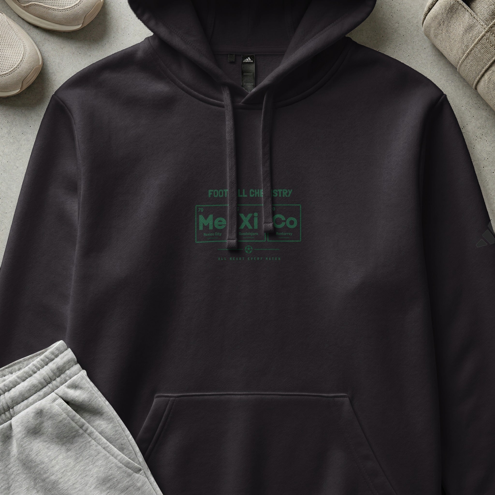 Dark gray hoodie with "FOOT LL CHE STRY" and "Me Xi Co" periodic table design.