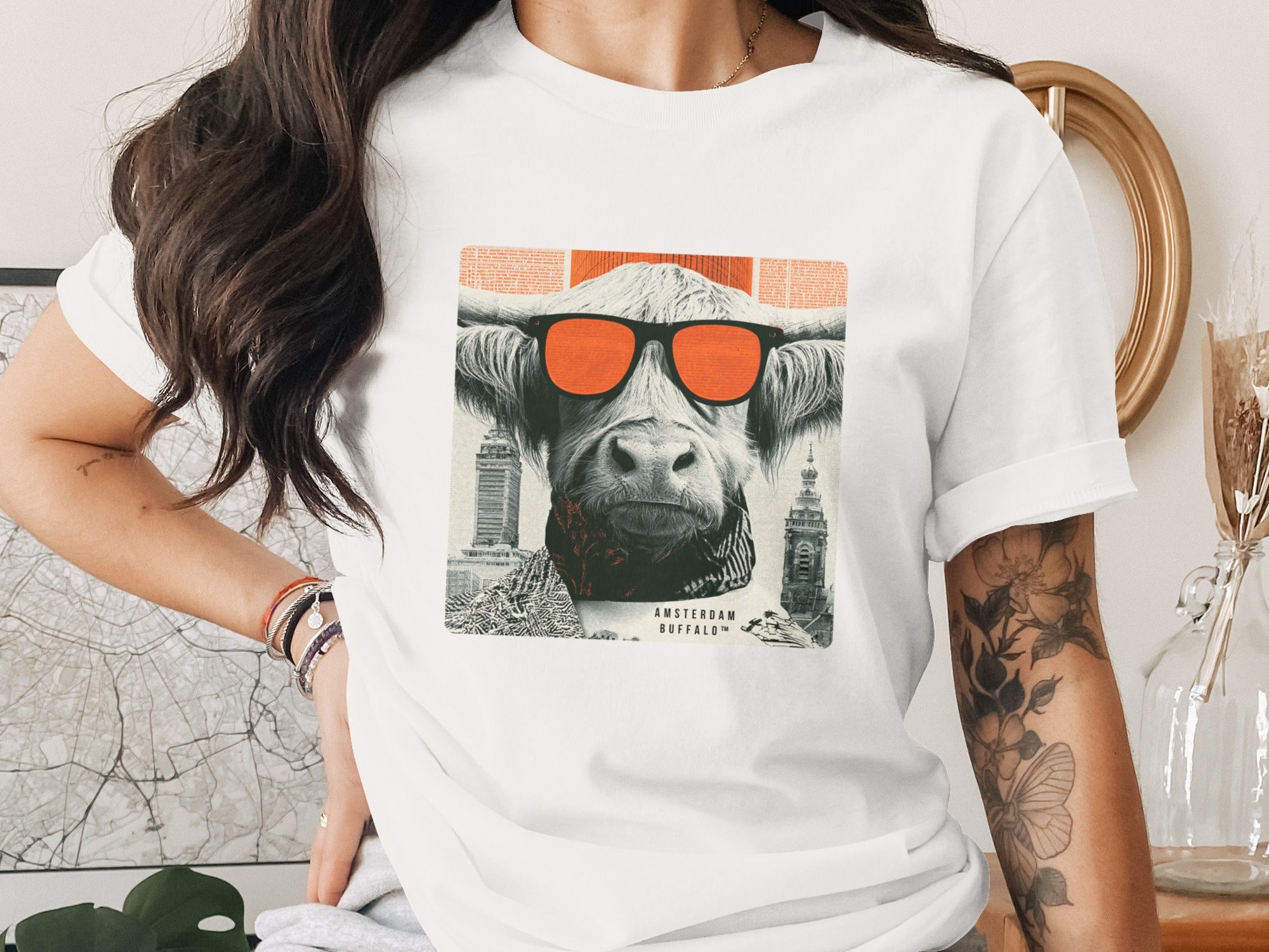 White t-shirt with graphic of a bull wearing sunglasses and cityscape.