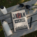 JAPAN FOOTBALL CHEMISTRY notebook cover with city names and soccer field graphic.