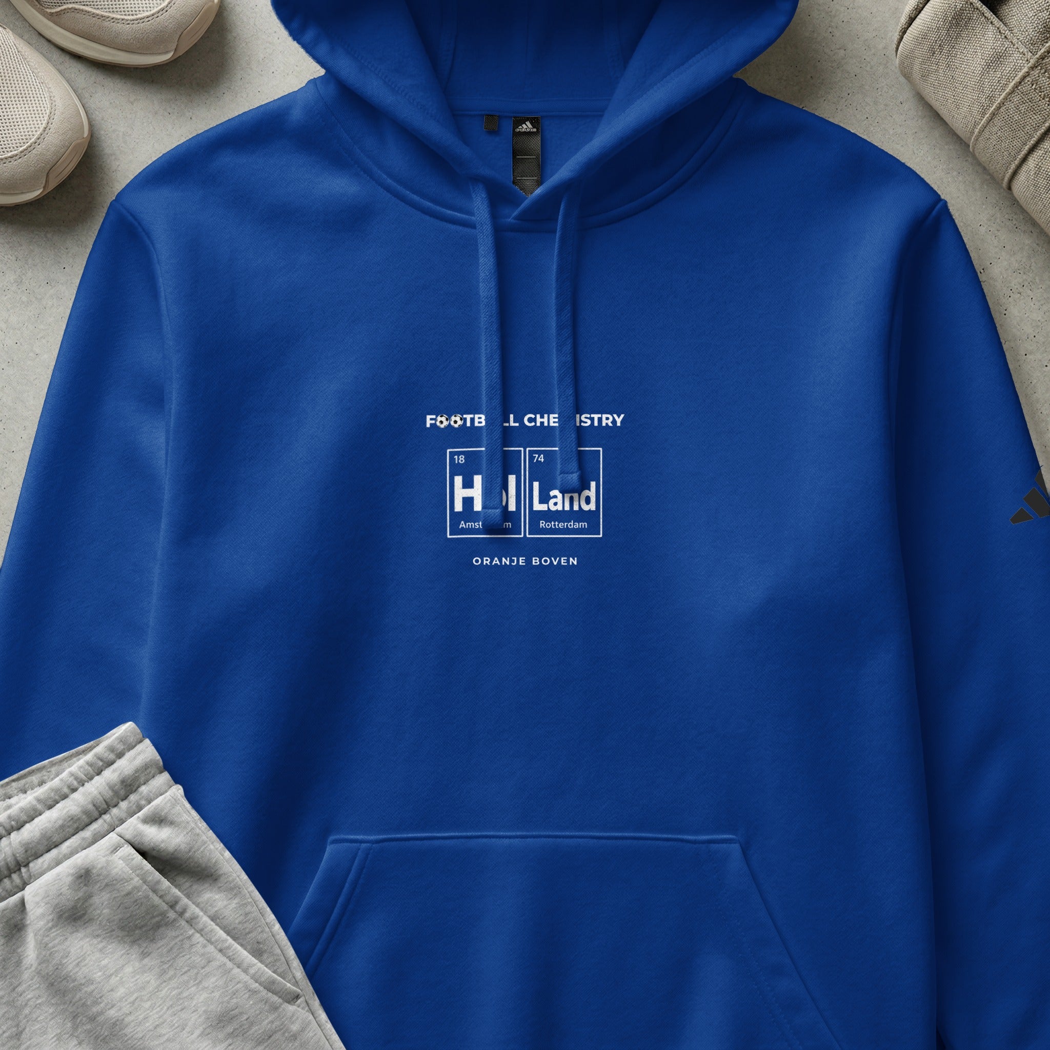 Blue hoodie with "FOOTBALL CHEMISTRY HOLLAND" text and periodic table elements.