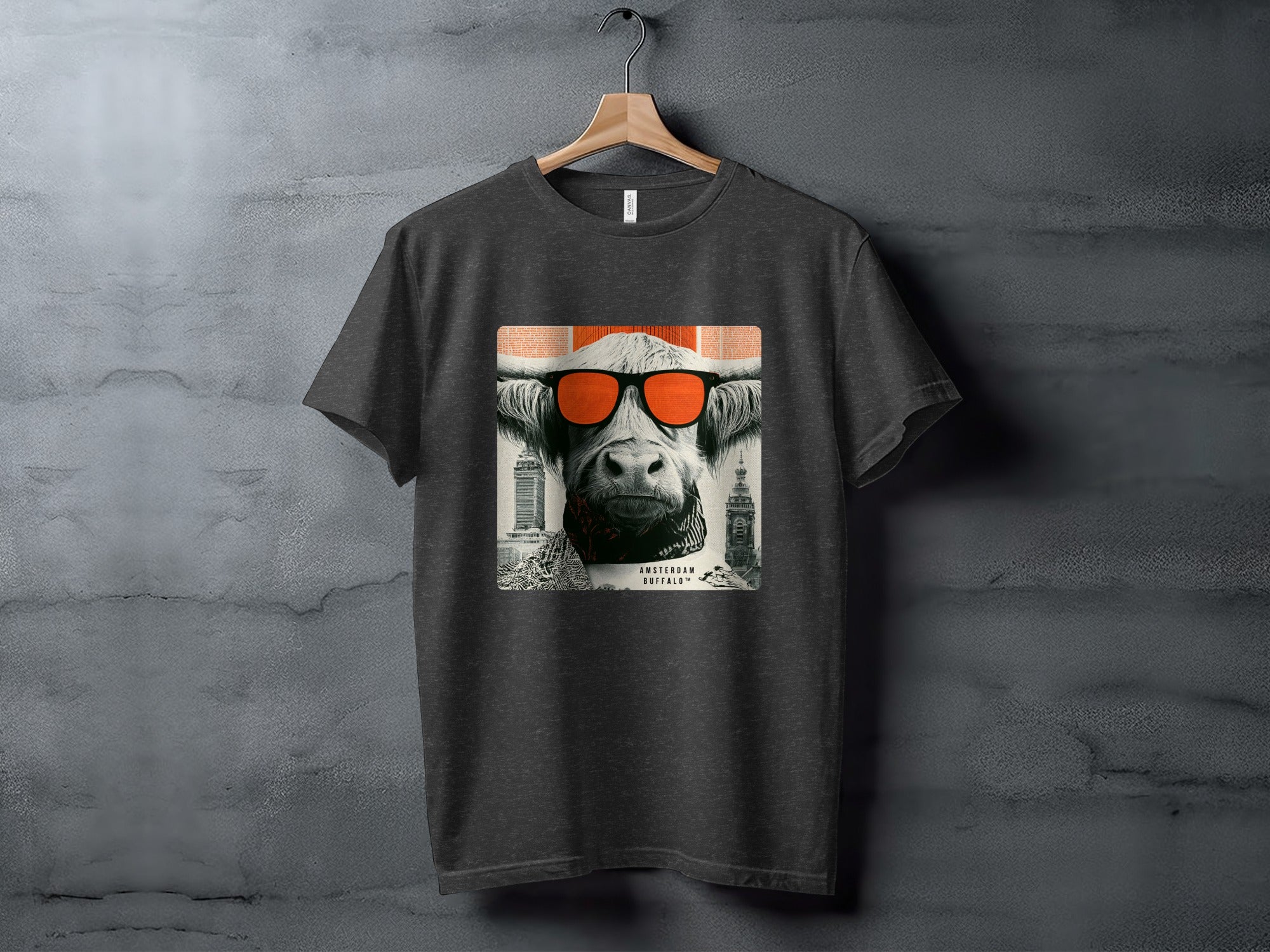 Dark t-shirt with graphic of a highland cow wearing orange sunglasses.