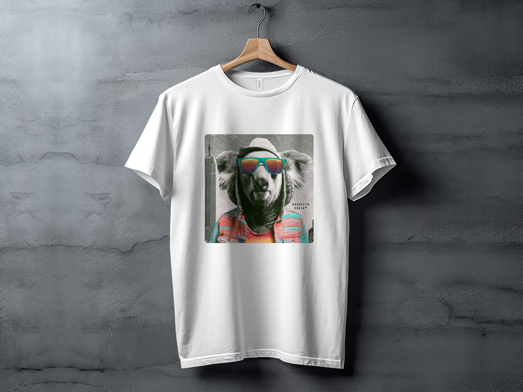 White t-shirt with graphic of a cool koala wearing sunglasses and a hat.