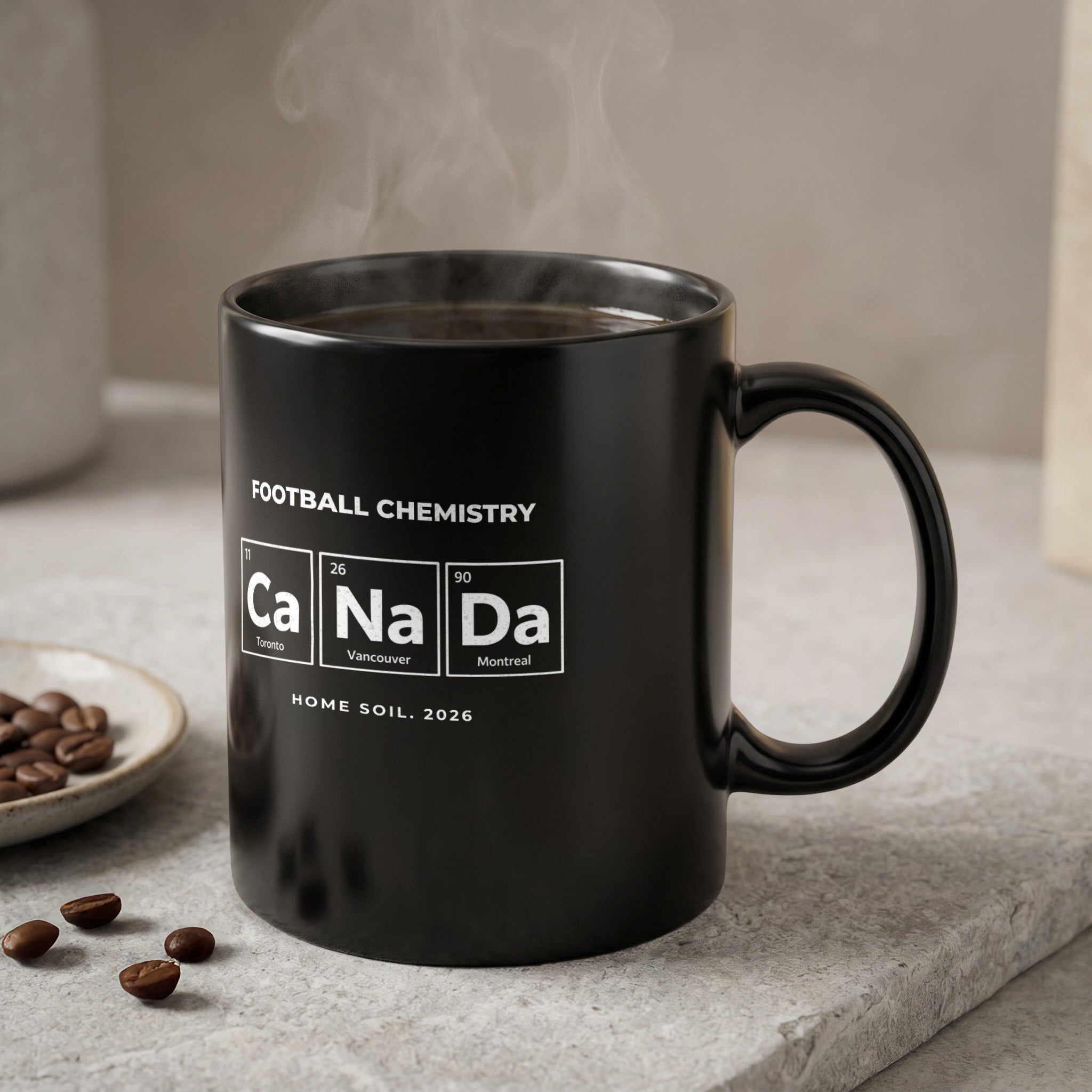 Black mug with periodic table elements spelling "Ca Na Da" and "HOME SOIL. 2026".