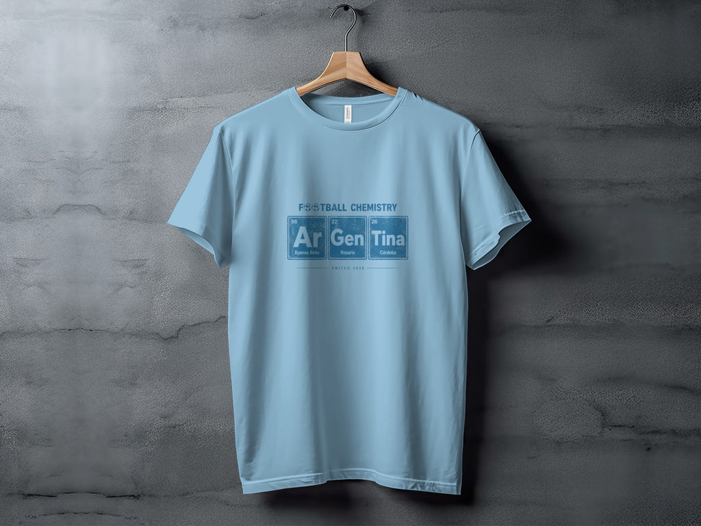 Light blue t-shirt with "FOOTBALL CHEMISTRY" and periodic table elements Ar, Gen, Tina.