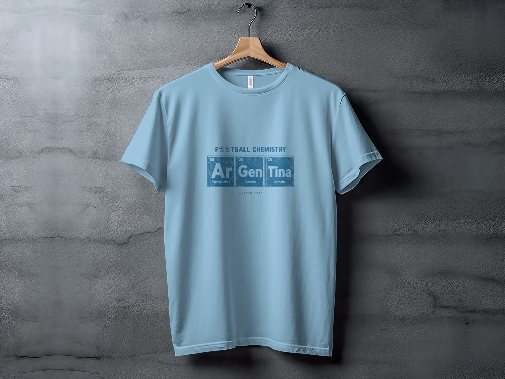 Light blue t-shirt with "FOOTBALL CHEMISTRY" and periodic table elements Ar, Gen, Tina.